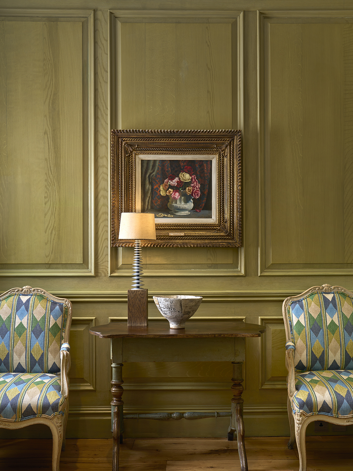 Close shot of artwork in the Library at Charlotte Street Hotel, with two chairs.