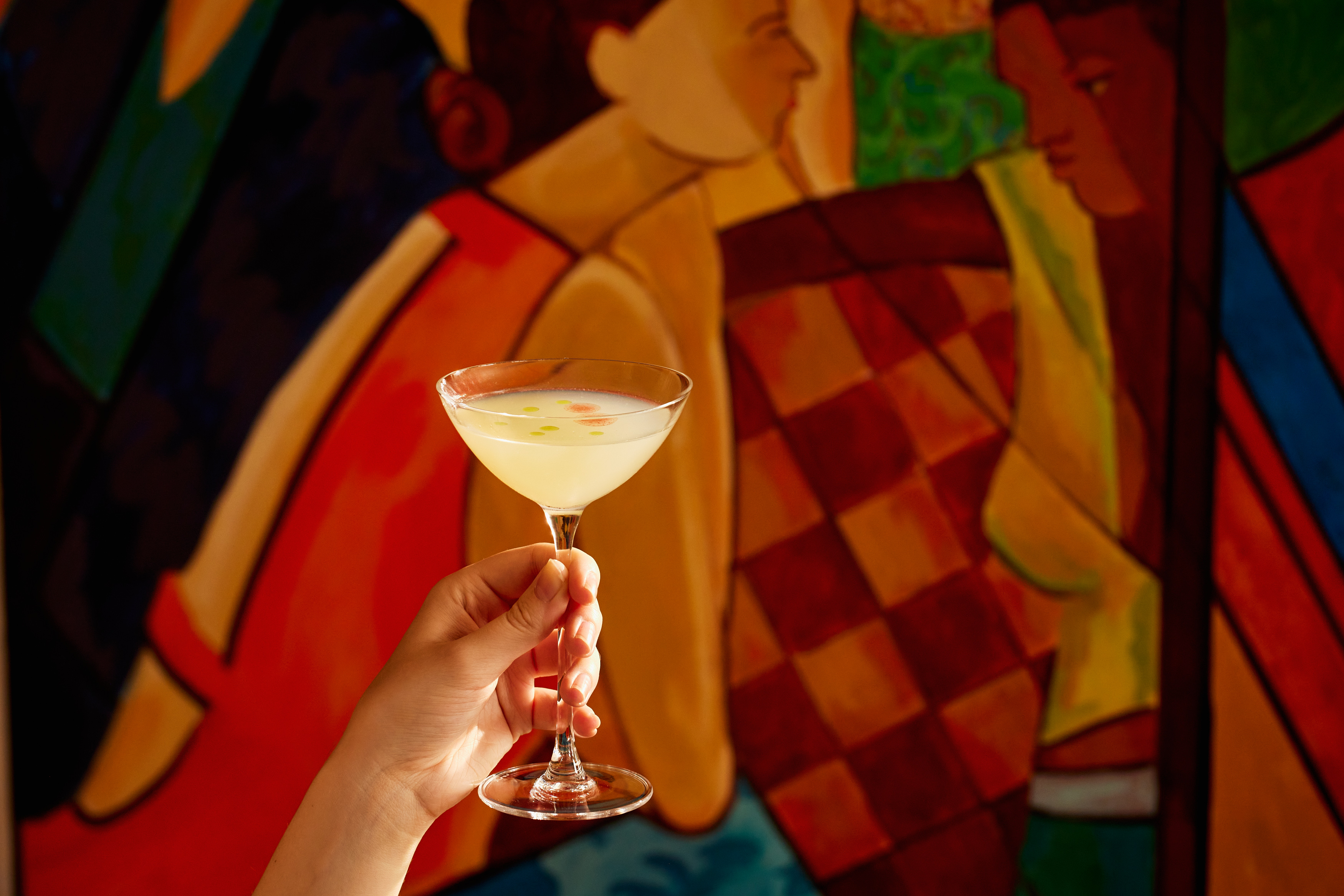 A close-up wide angle shot of the 'Mural You Look' cocktail from the Bloomsbury Group cocktail collection at Oscar Bar & Restaurant