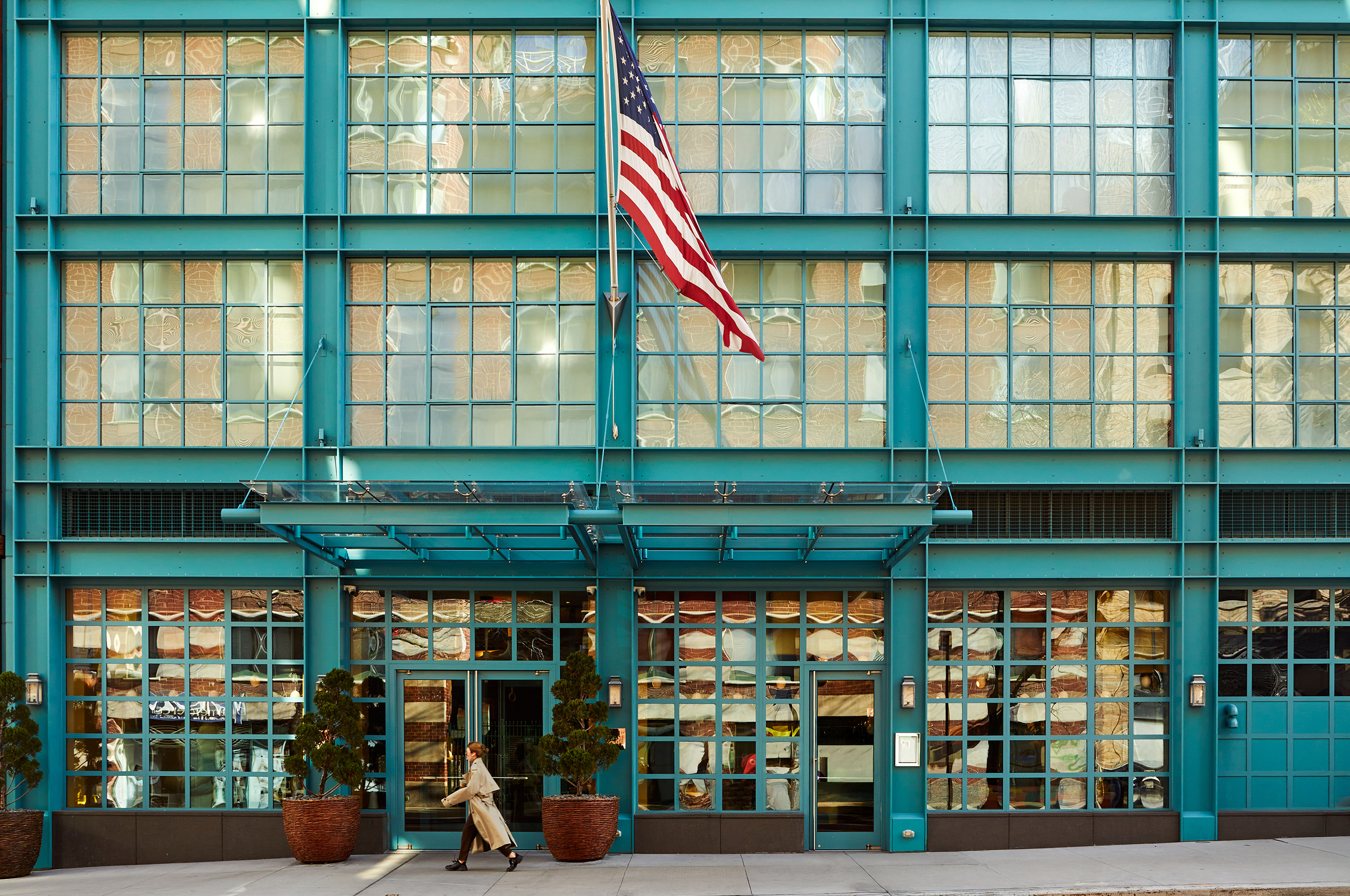 A close up shot of the entrance of the Warren Street Hotel, with the flag.
