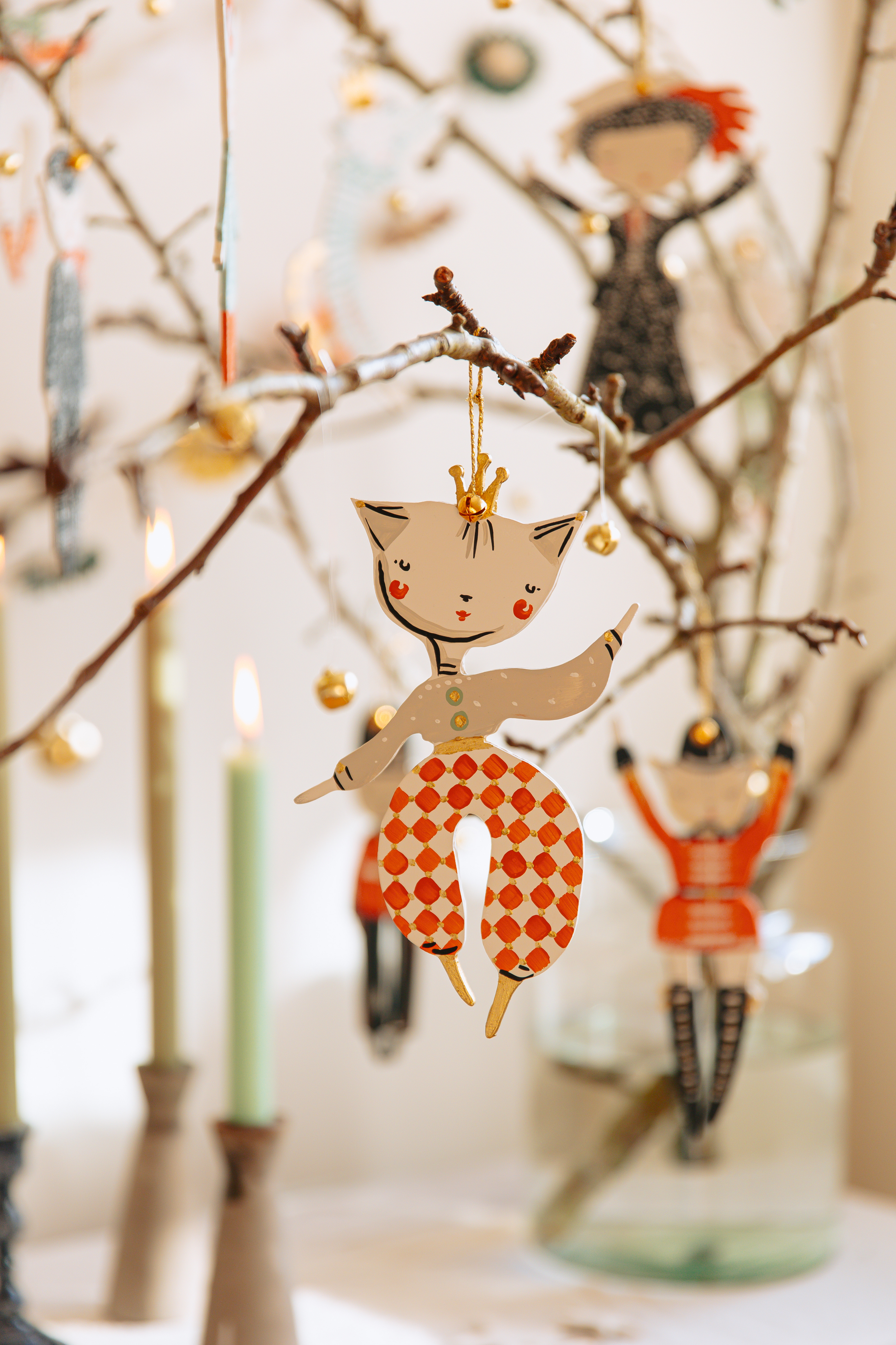 A Christmas decoration by Alice Mary Lynch hanging on a small branch