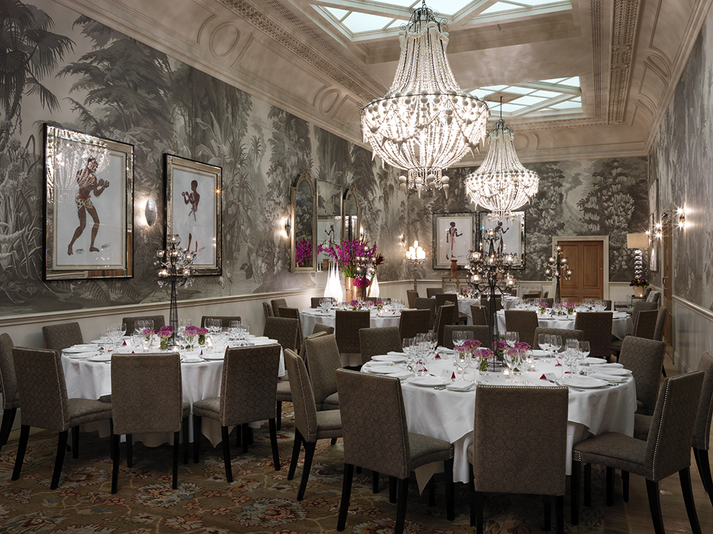 Round dining tables in the Shooting Gallery private events room at Haymarket Hotel