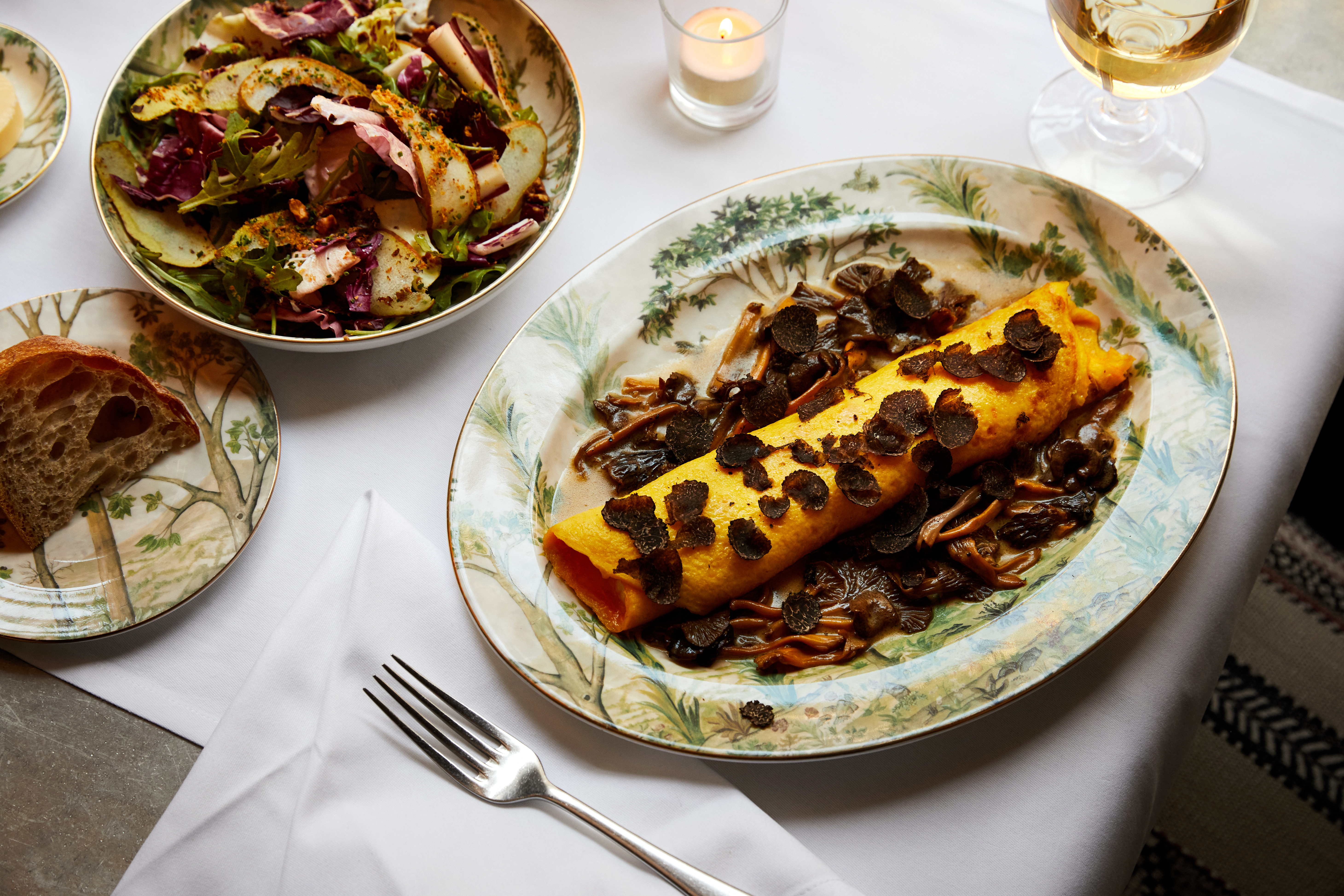 A main course of truffle omelette with a side salad on a plate at Brasserie Max