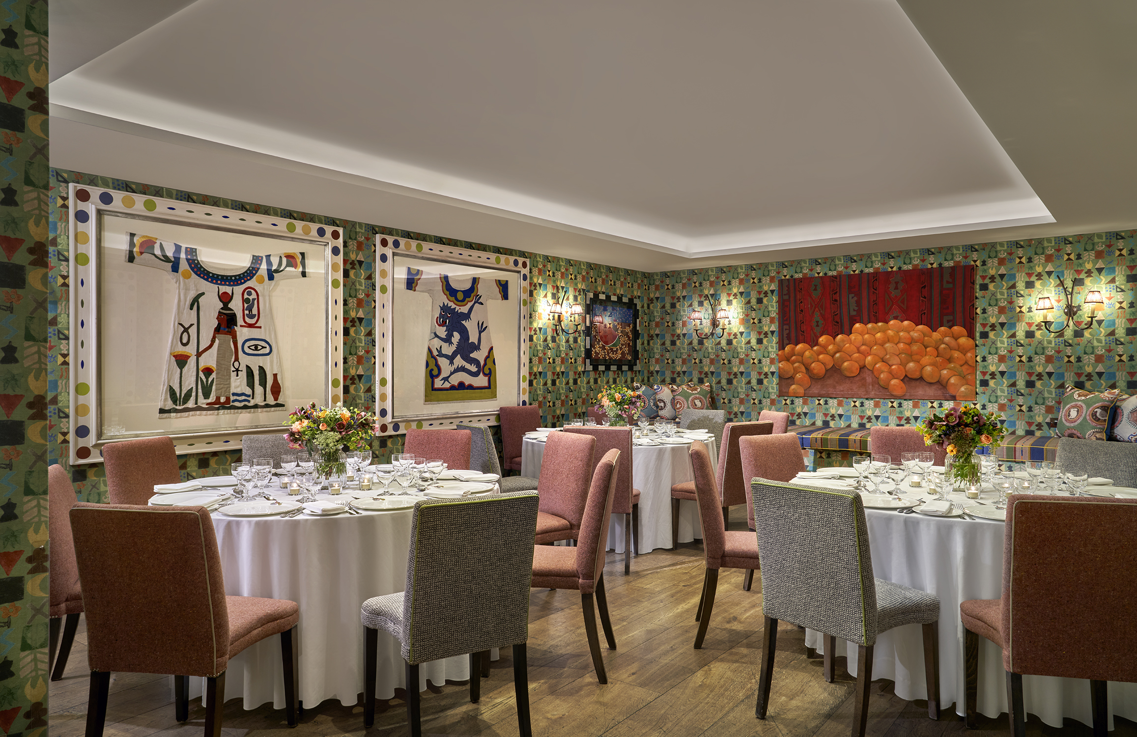 A round dining tables set-up in the Vanessa Bell private events room at Charlotte Street Hotel