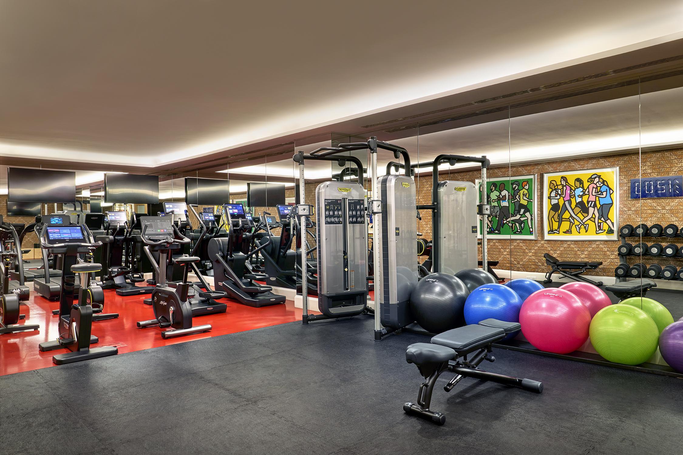 The gym space at The Whitby Hotel, New York with a variety of exercise and weight machines