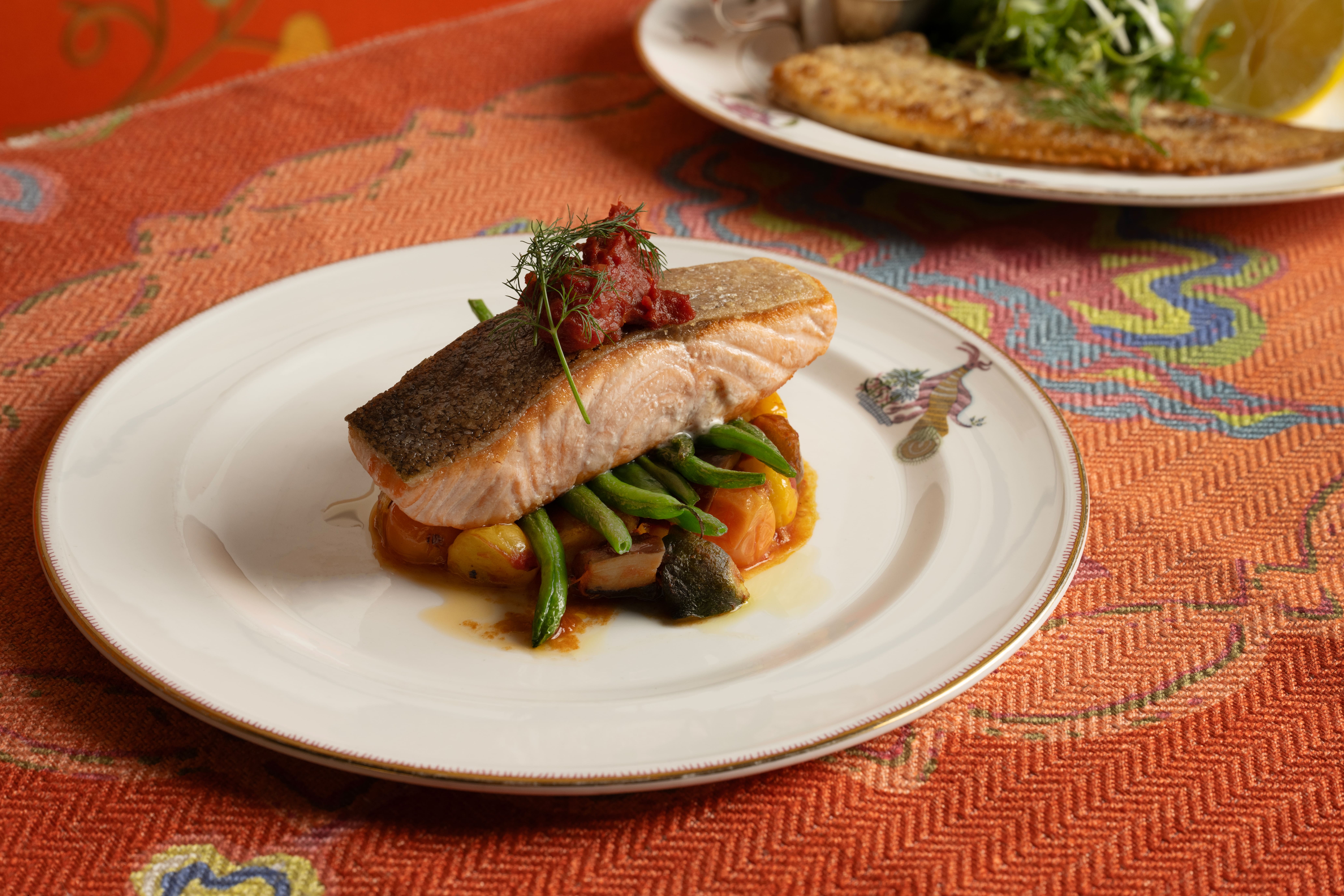 A wide angle close-up shot of the seared salmon with French beans at The Crosby Bar