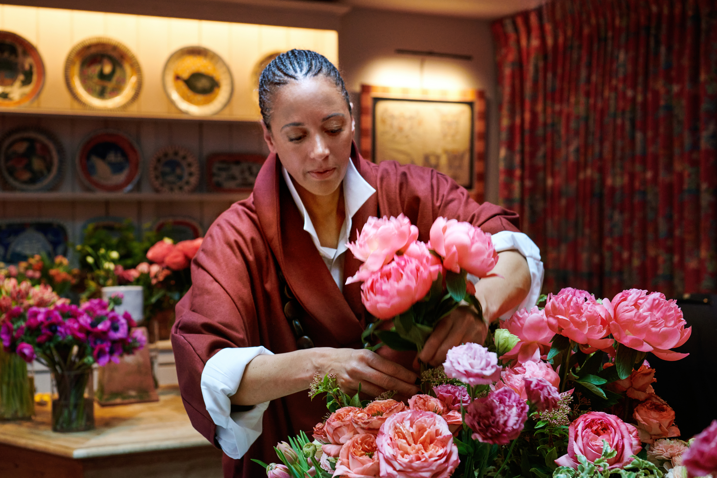 Shot of floral designer Tawana Schlegel arranging some bright pink flowers