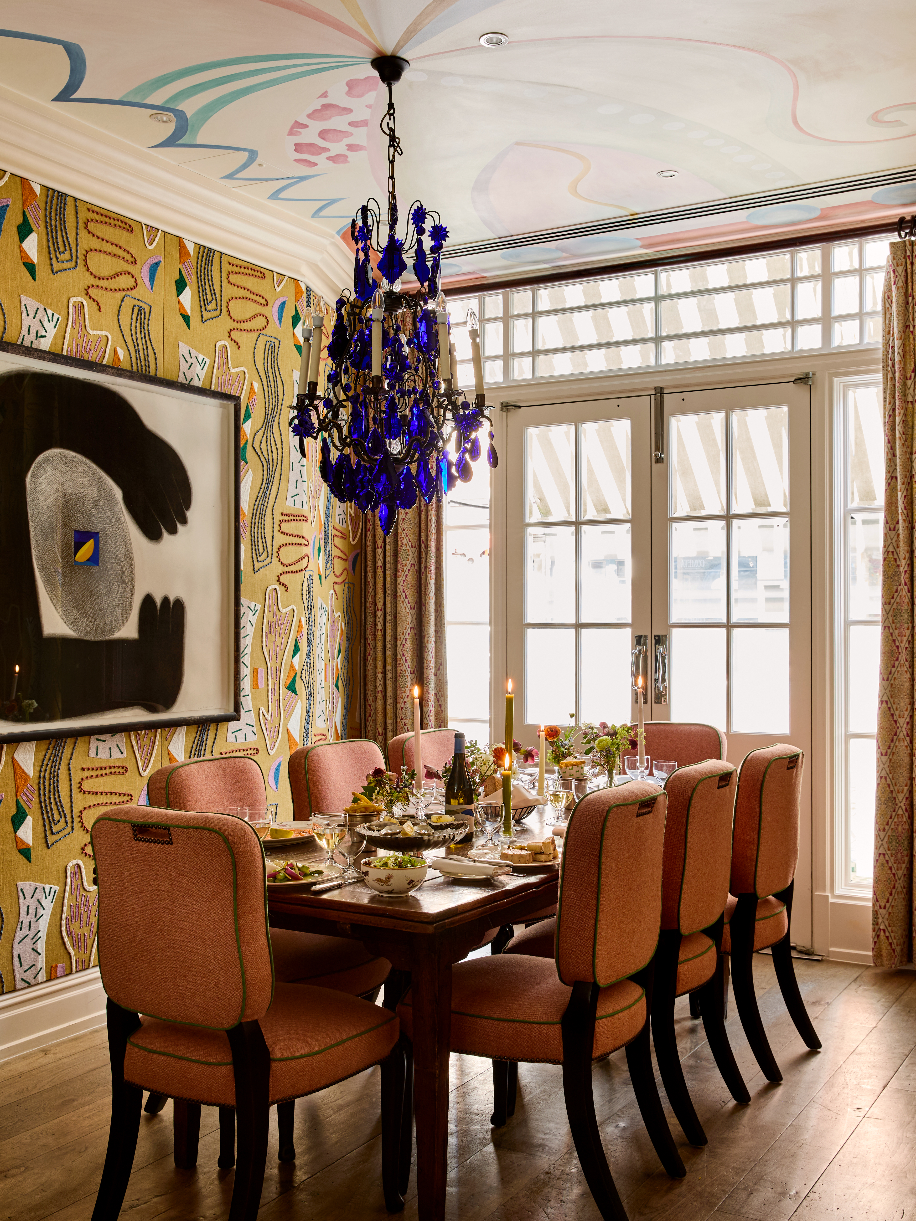 A portrait shot of the Dora Carrington event space at Charlotte Street Hotel: the table is set up for private dining for eight people with lunch dishes being shared