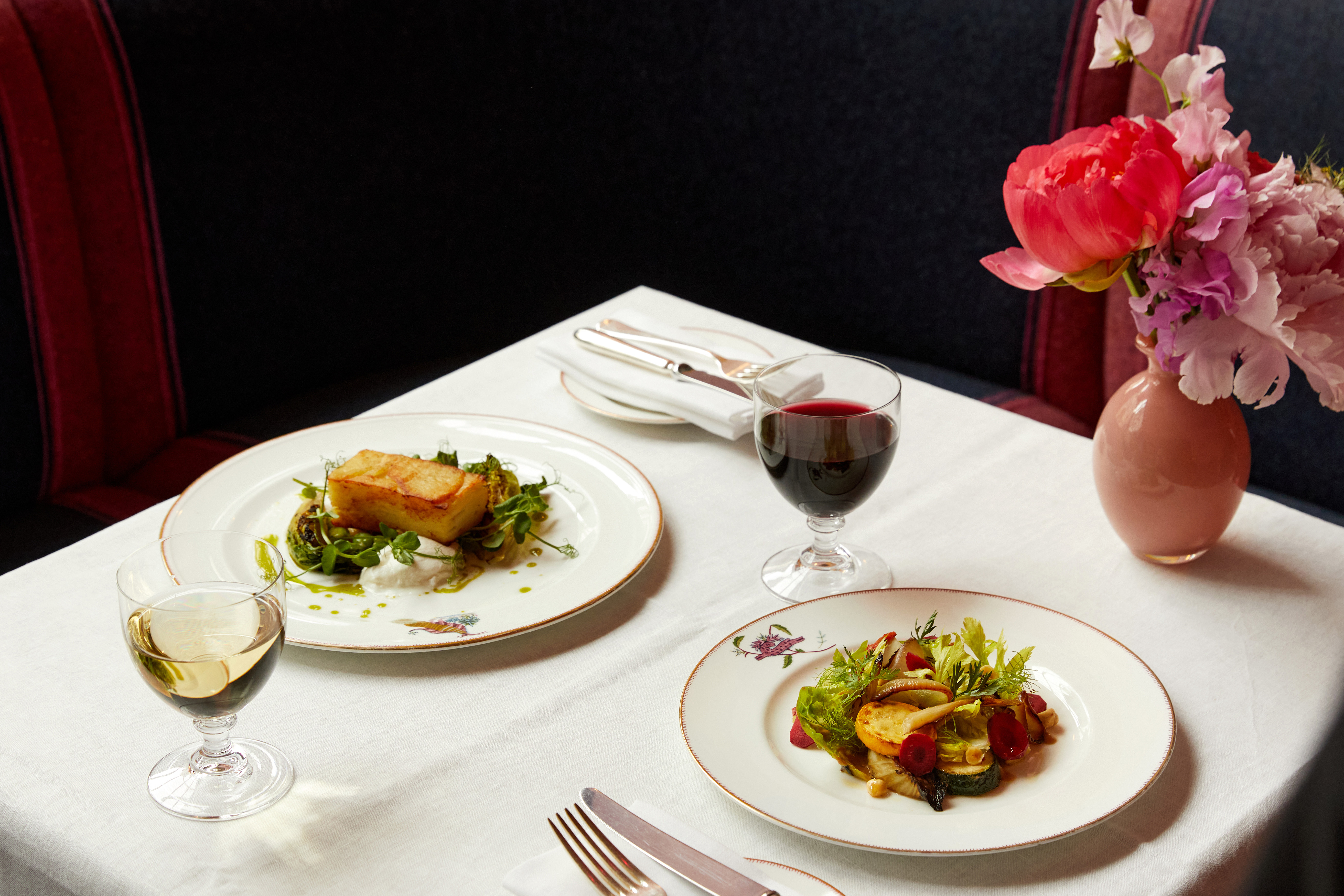 Main courses of roast potato and vegetable salad on plates at Brumus