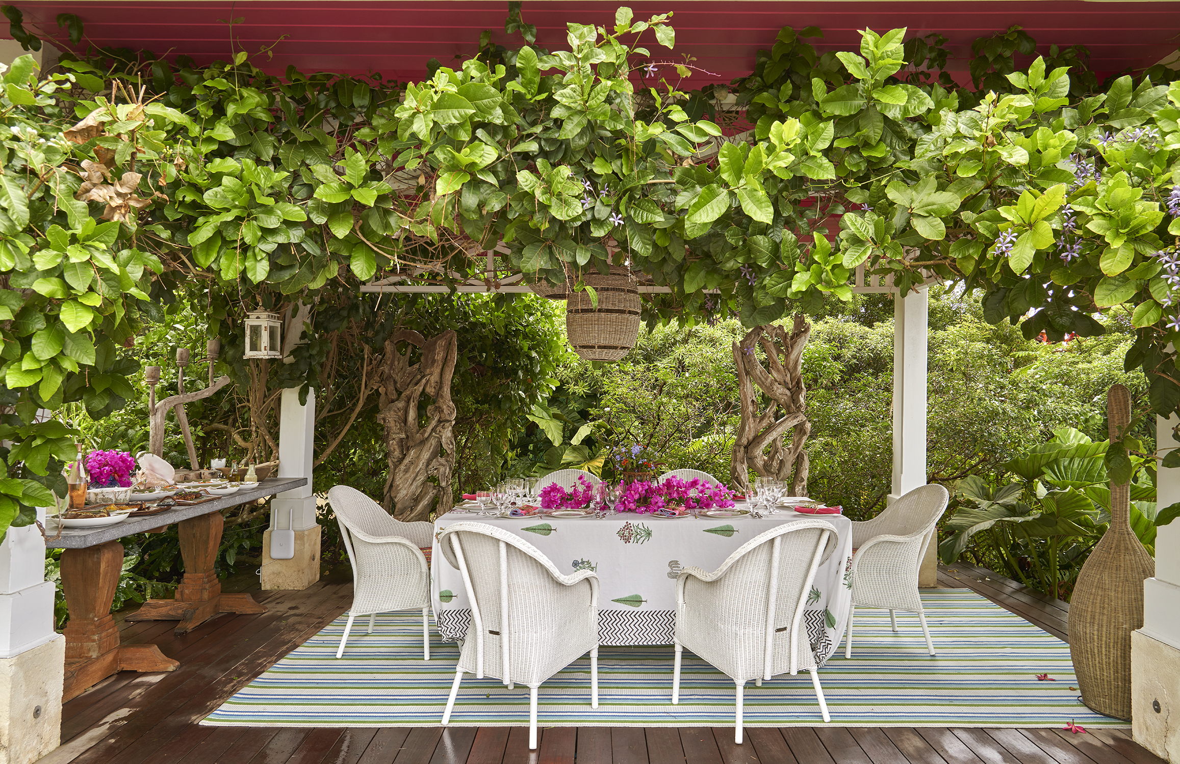 A close up image of the terrace at the side of the pool used for dining. At Rossferry, the Caribbean property manged by Firmdale.