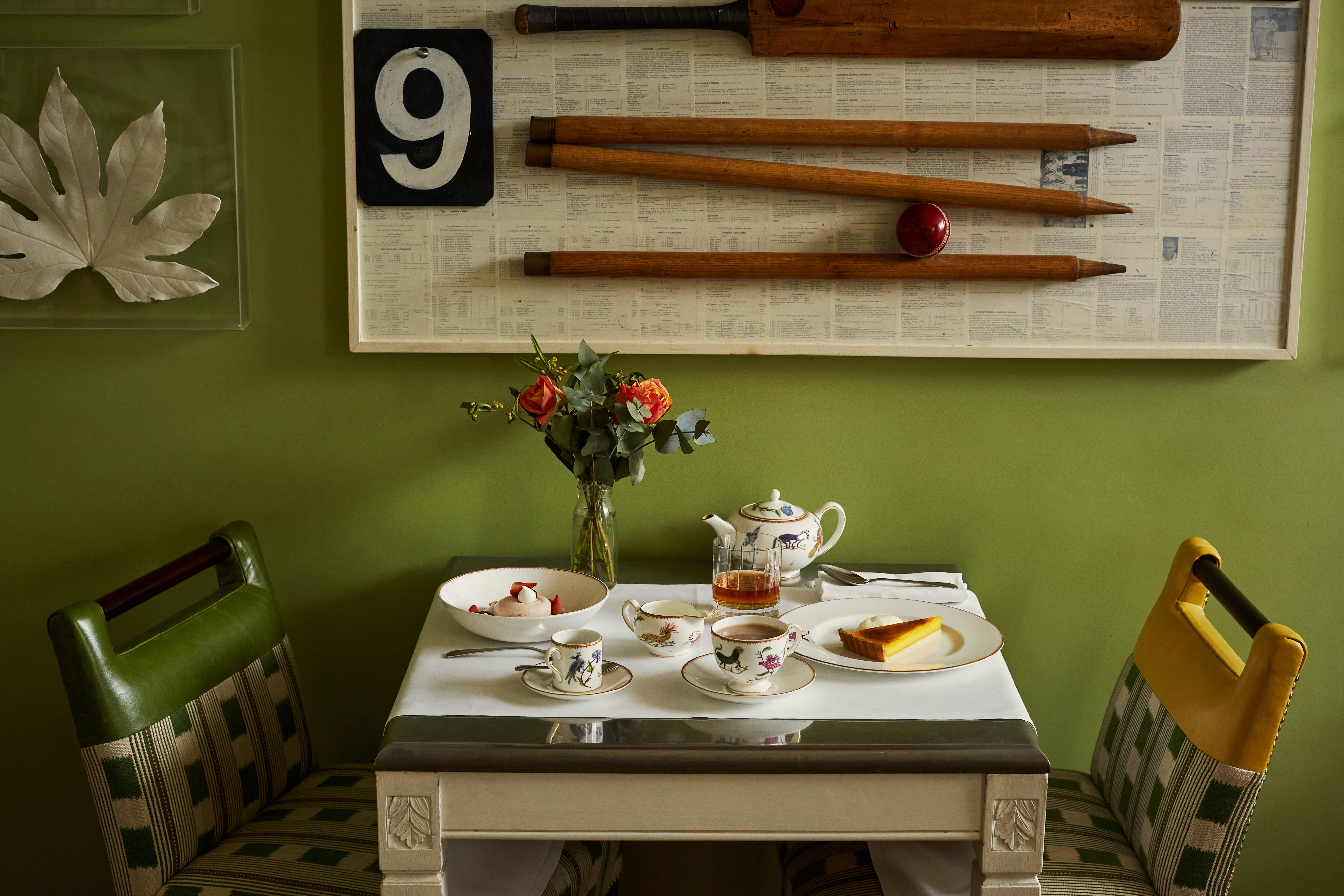 Wide shot of a table of desserts at The Potting Shed. Plates of lemon tart and meringue accompanied by tea