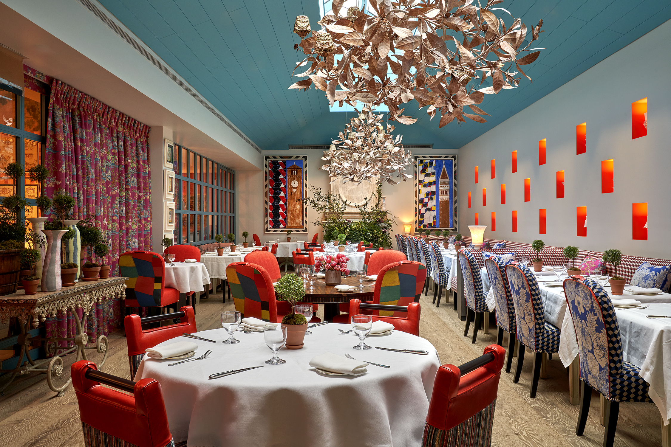 Round and long dining tables set-up in the Orangery private events room at Warren Street Hotel