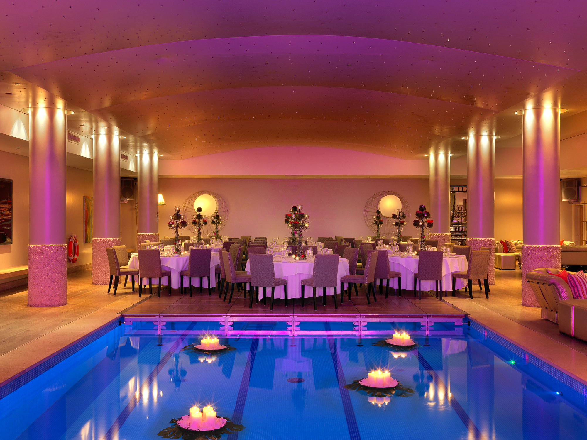 An image of the evening dining set up by the swimming pool at Haymarket Hotel