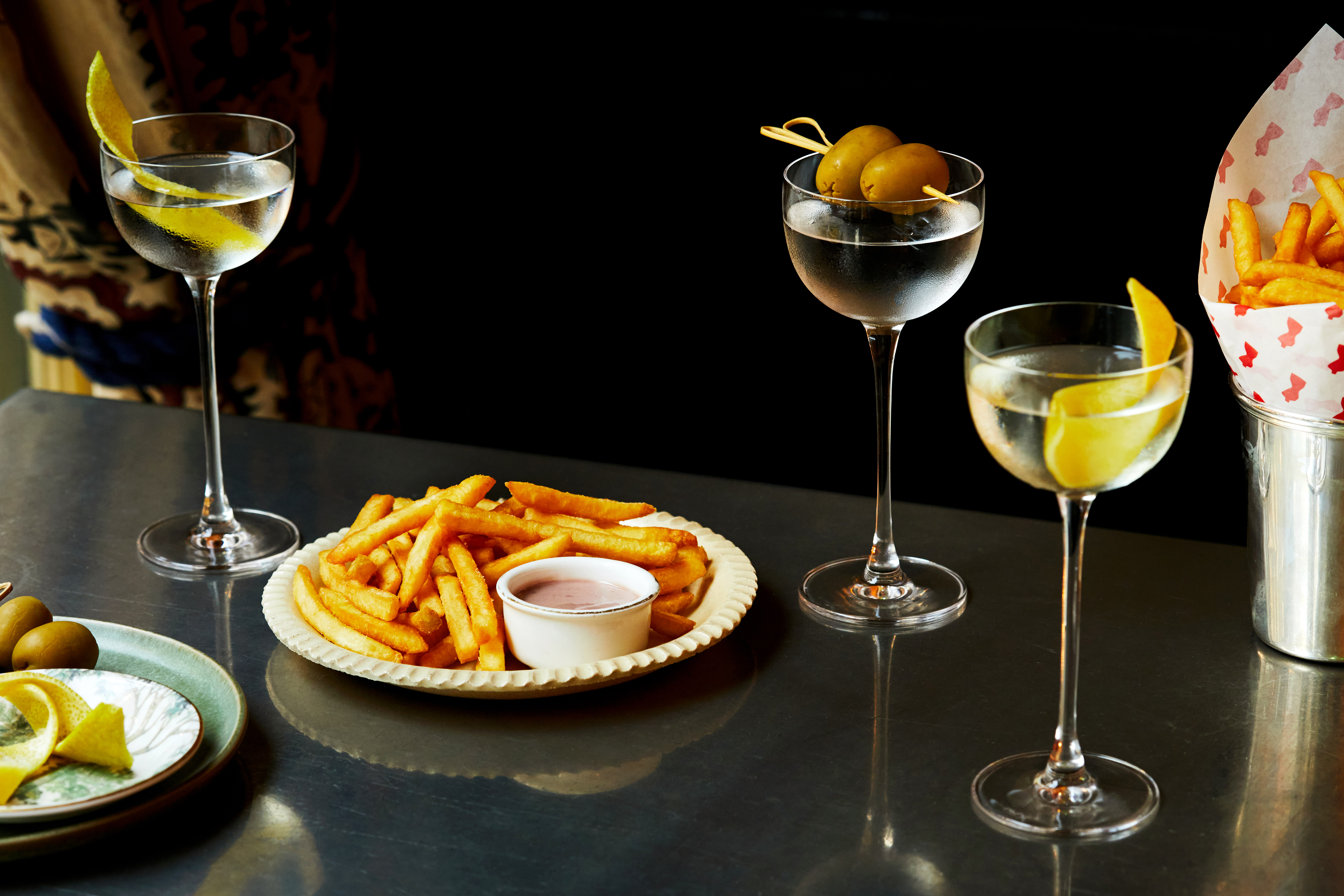 Martini Hour at Brasserie Max. A table of martinis and fries on a table