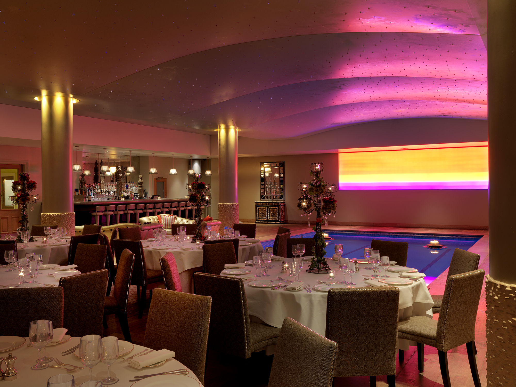 Diagonal shot of round dining tables in the Swimming pool private events room at Haymarket Hotel