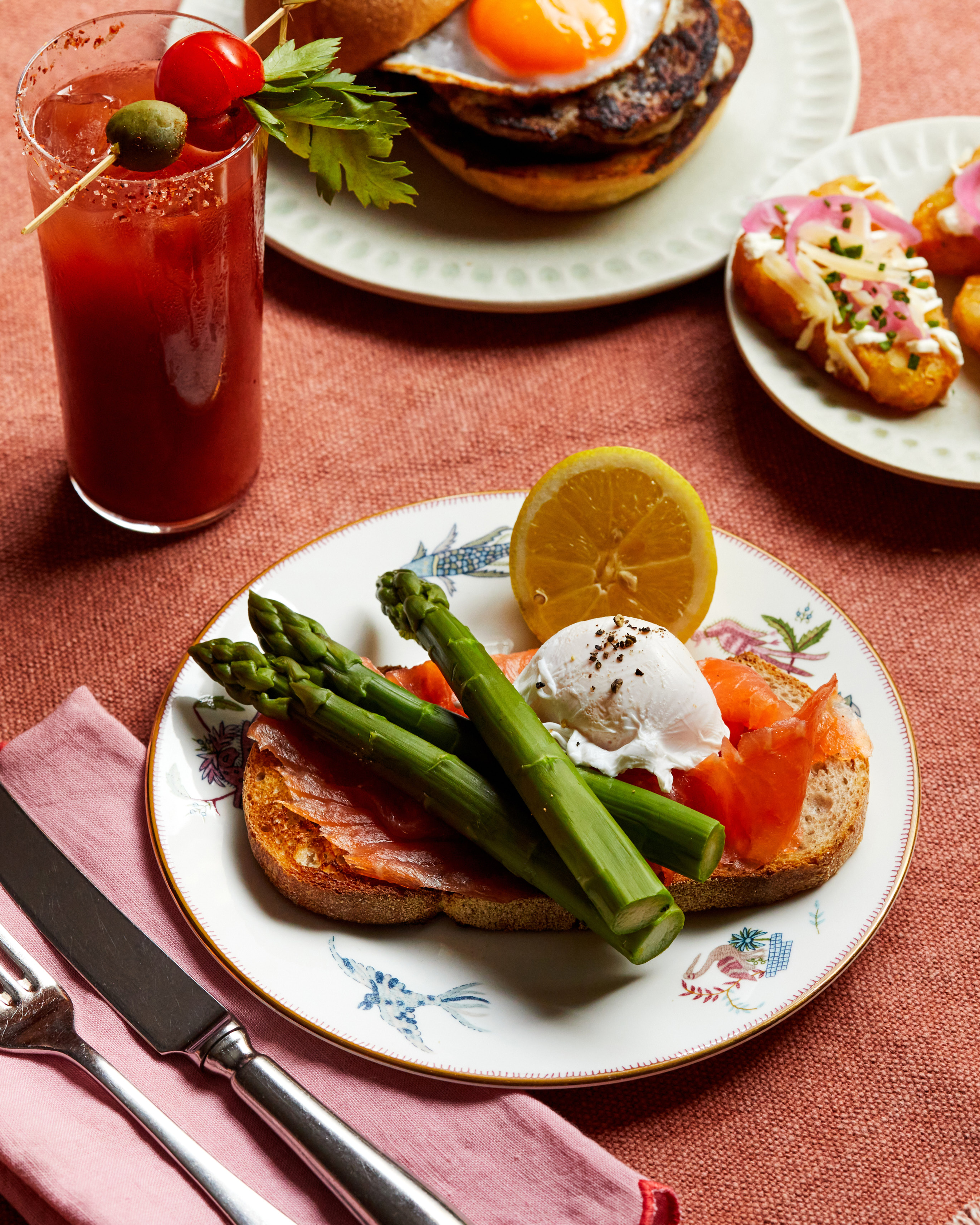 An image of the Mary Fitzrovia cocktail and Enderby smoked salmon with poached egg and asparagus to promote Weekend Brunch at Oscar, Charlotte Street Hotel.