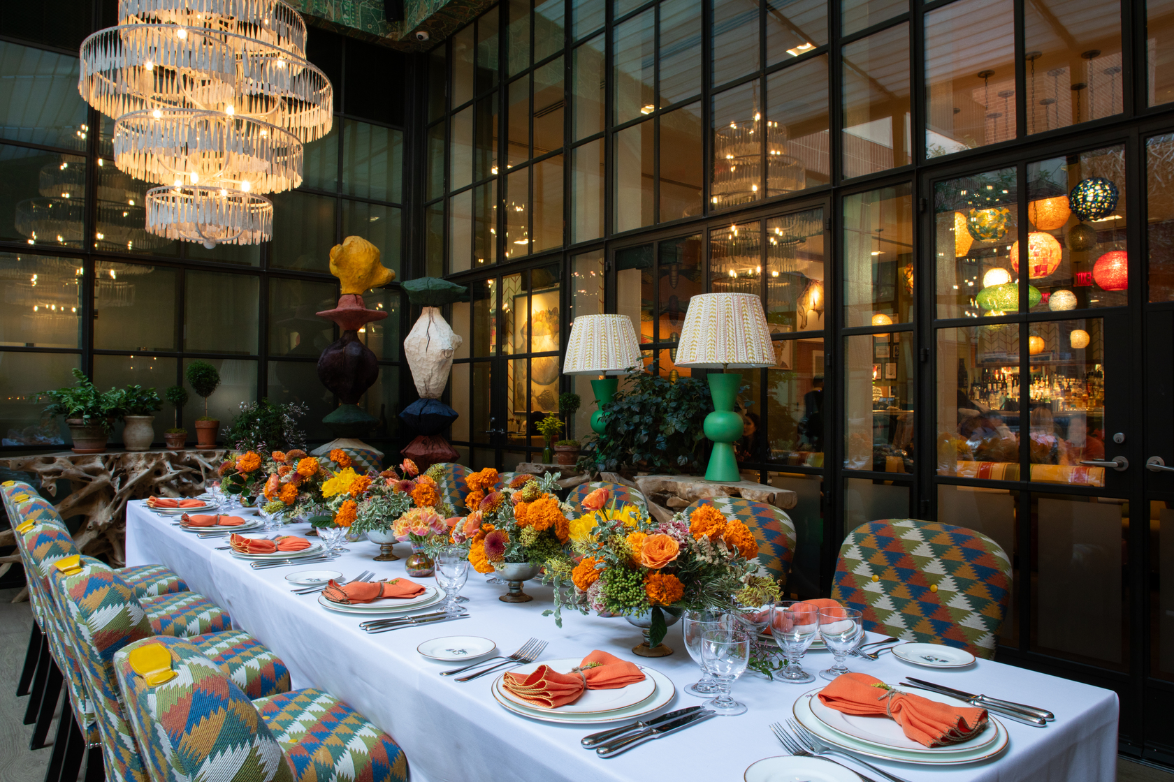 Image of a long table set up for lunch in The Orangery at Crosby Street Hotel.