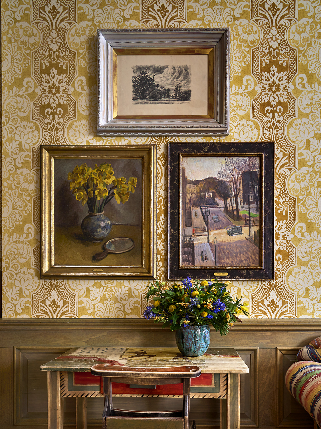 A series of paintings from Bloomsbury Group articles hang against patterned wallpaper at Charlotte Street Hotel in London