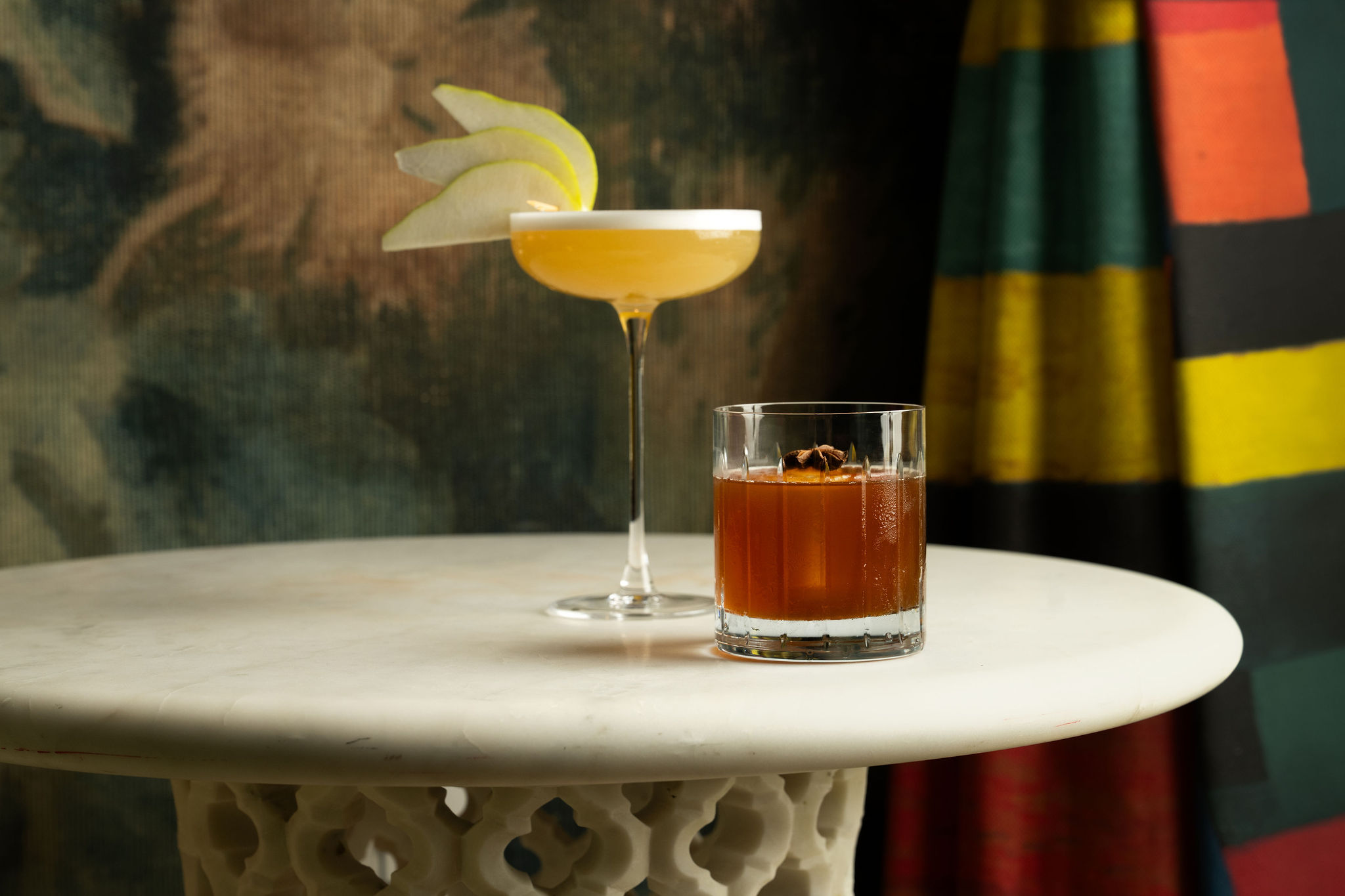 A landscape shot of two of the signature cocktails garnished with apple at Warren Street Bar, Warren Street Hotel