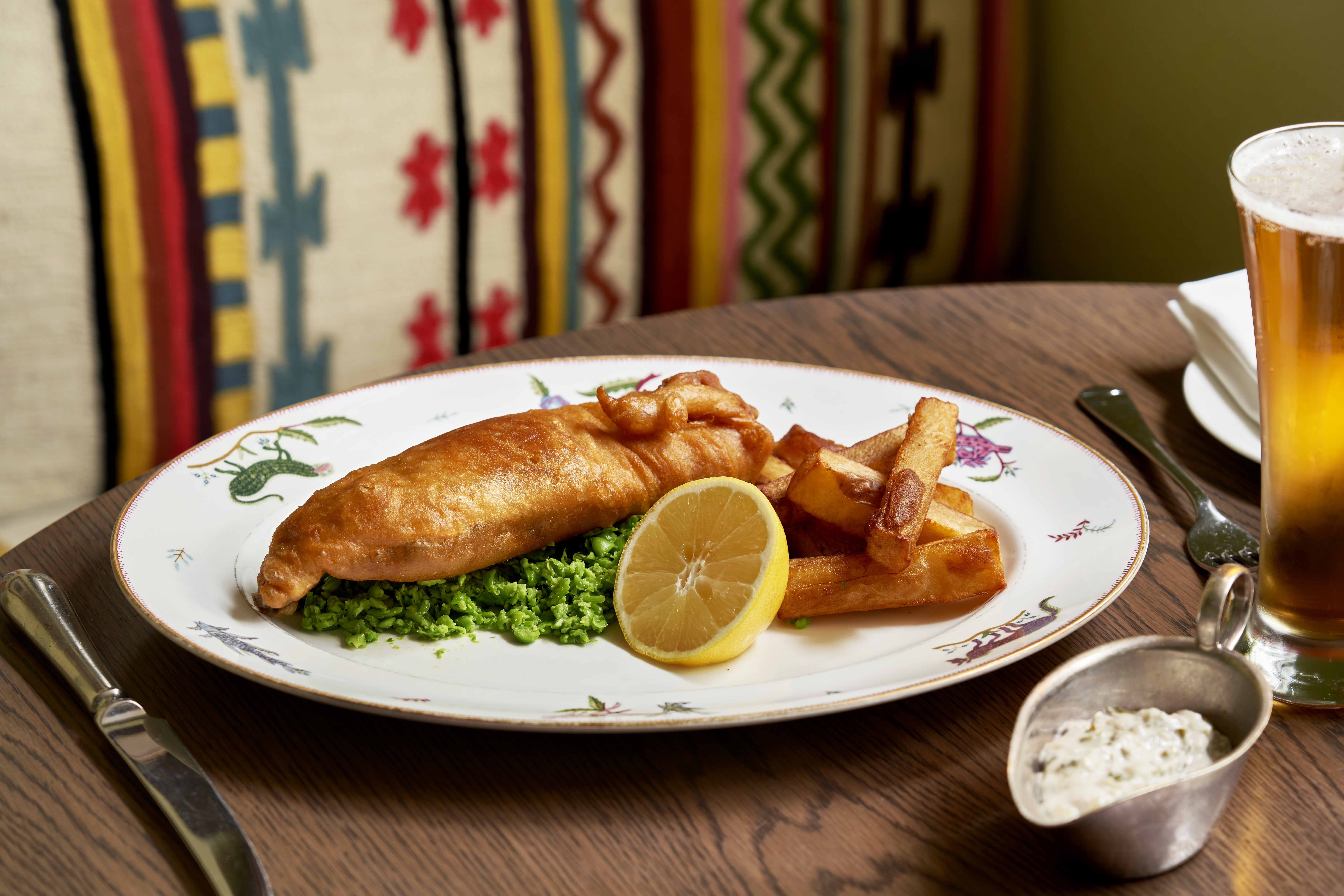Close up shot of a main course of fish and chips with tartare sauce on a plate at The Potting Shed