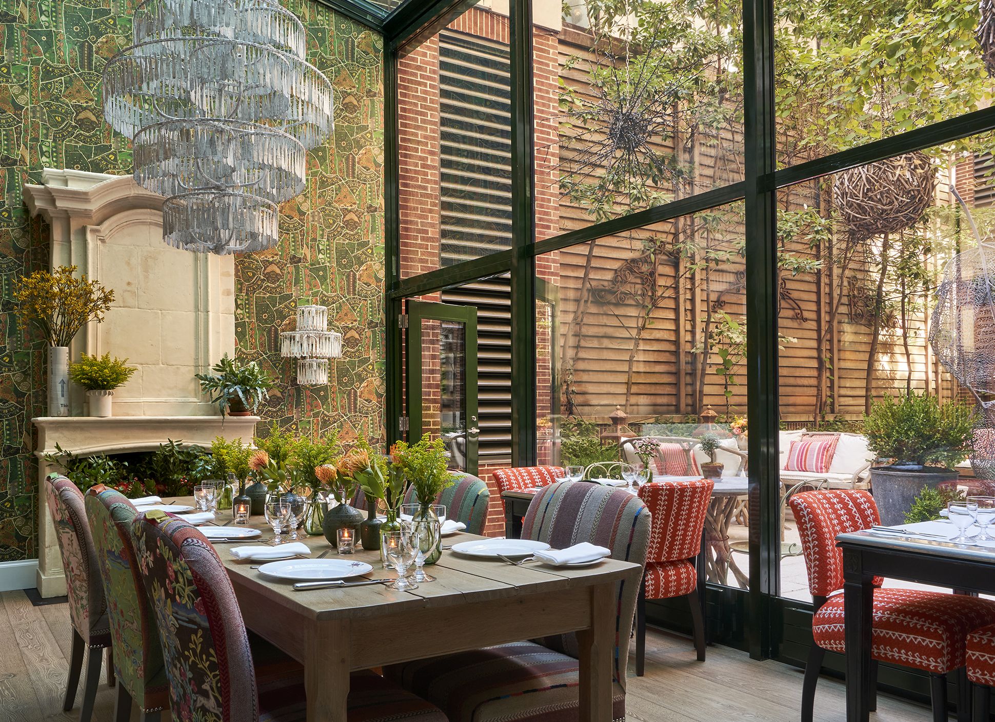 Diagonal shot a long dining table set-up in the Orangery private events rooms at Crosby Street Hotel