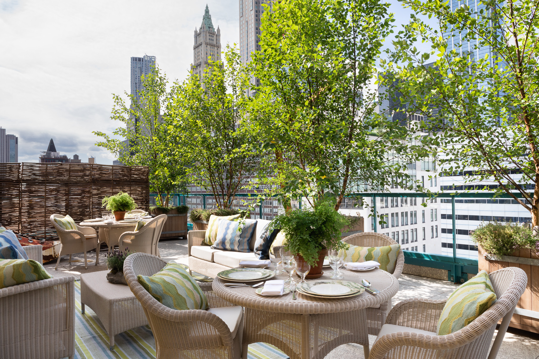 Wide shot of dining tables and lounge area on the Rooftop Terrace at Warren Street Hotel