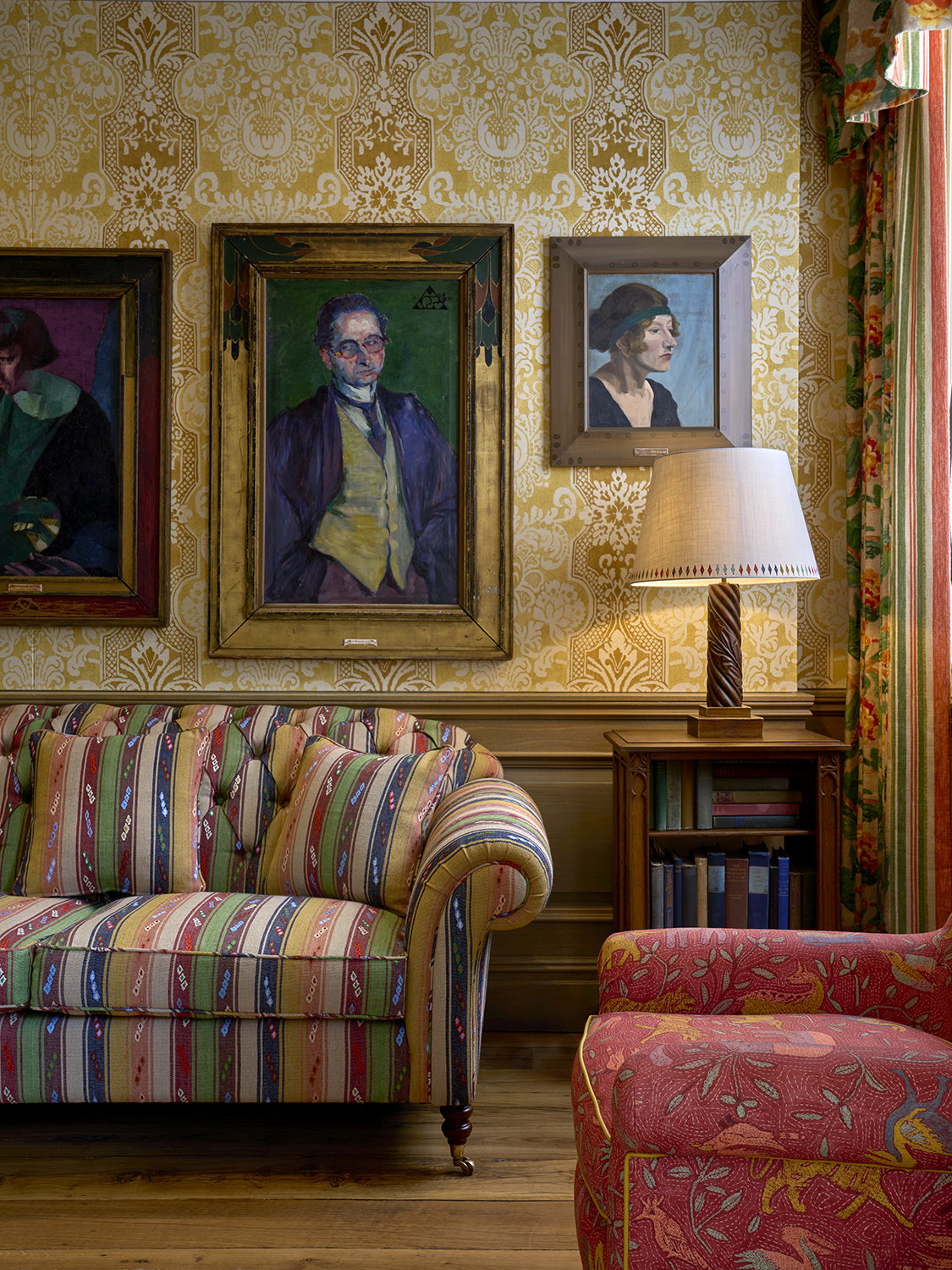 Paintings hang above a patterned sofa at Charlotte Street Hotel