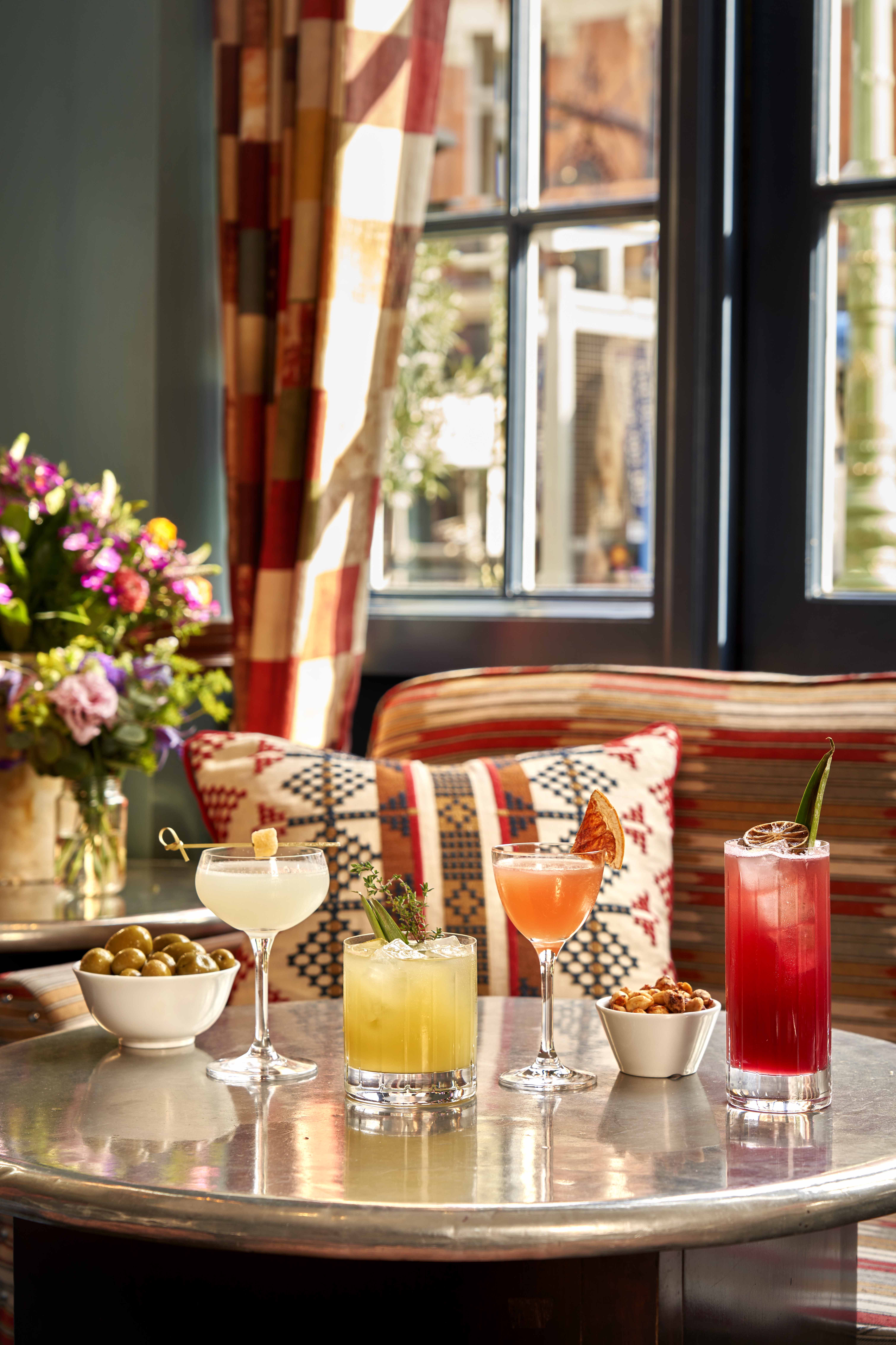 Wide portrait shot of cocktails and bar snacks at Oscar