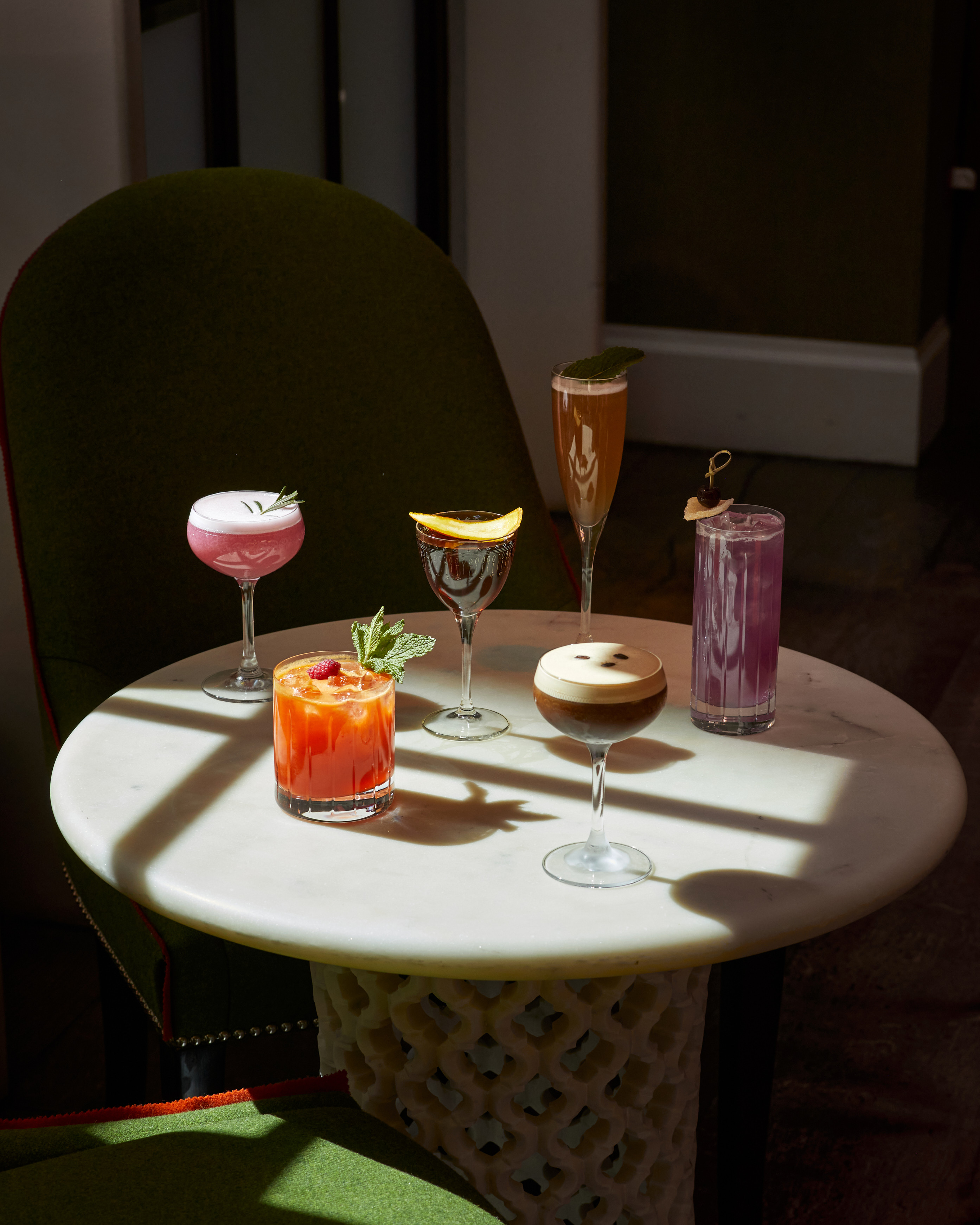 An image of multiple cocktails on a table in The Crosby Bar.