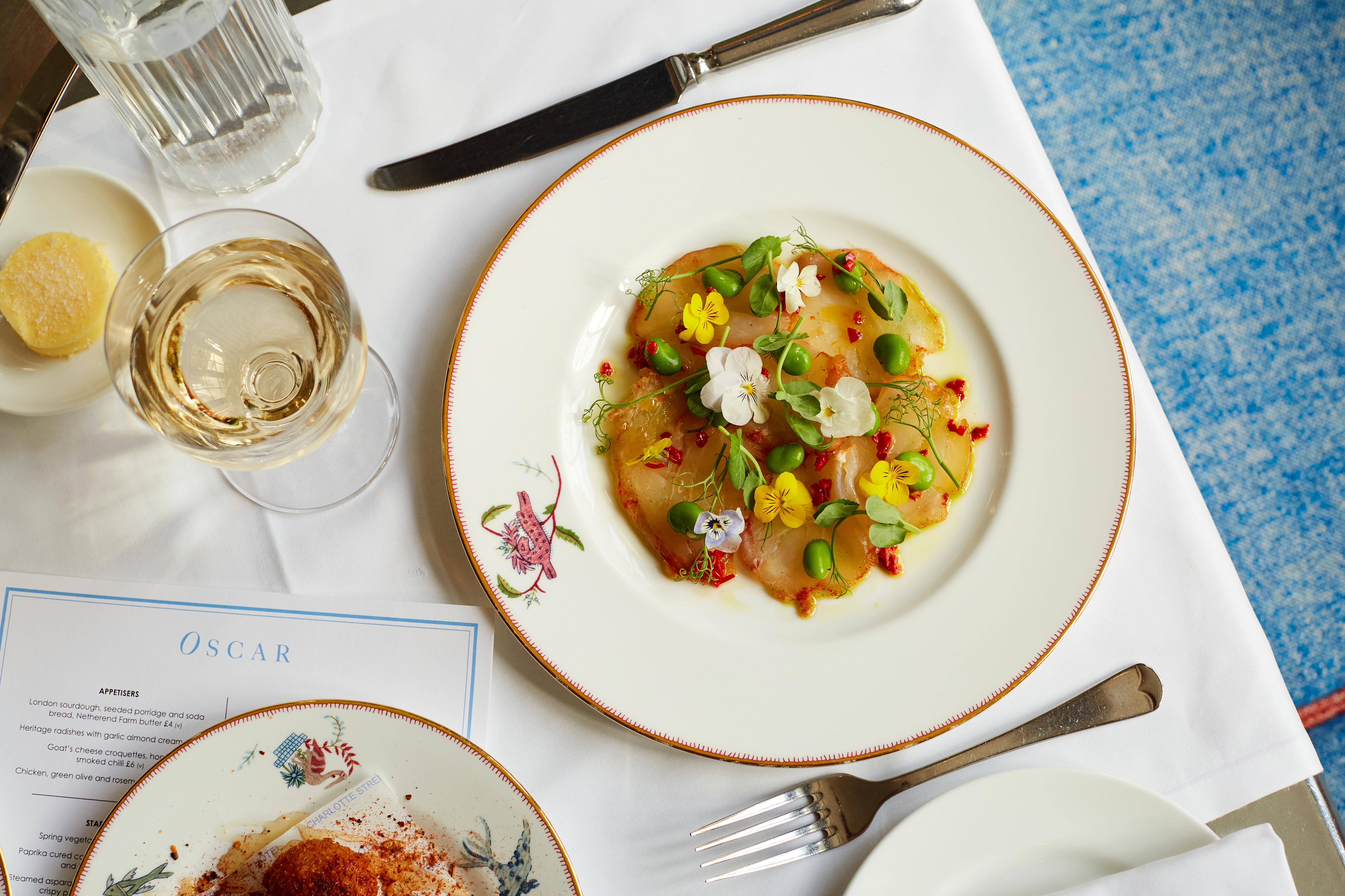 Close up shot of cured cod starter taken from above on a plate at Oscar