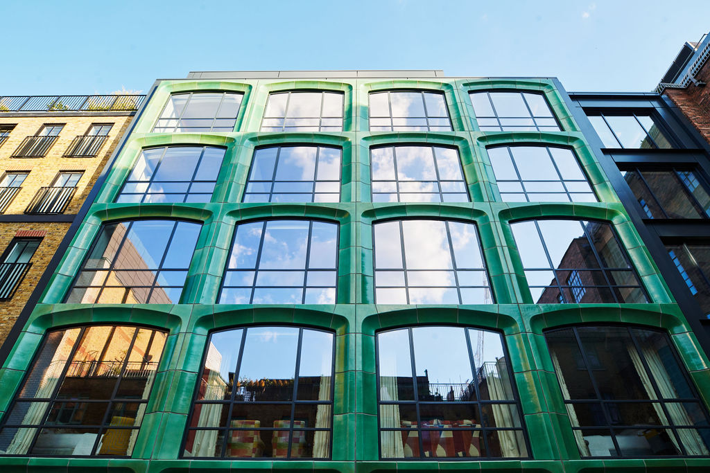 A wide shot of the striking ceramic green facade of 9 - 11 Richmond Buildings in Soho London