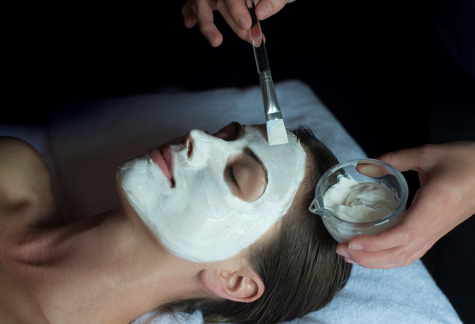 A lady is given a facial in a treatment room at Soholistic Spa at Ham Yard Hotel