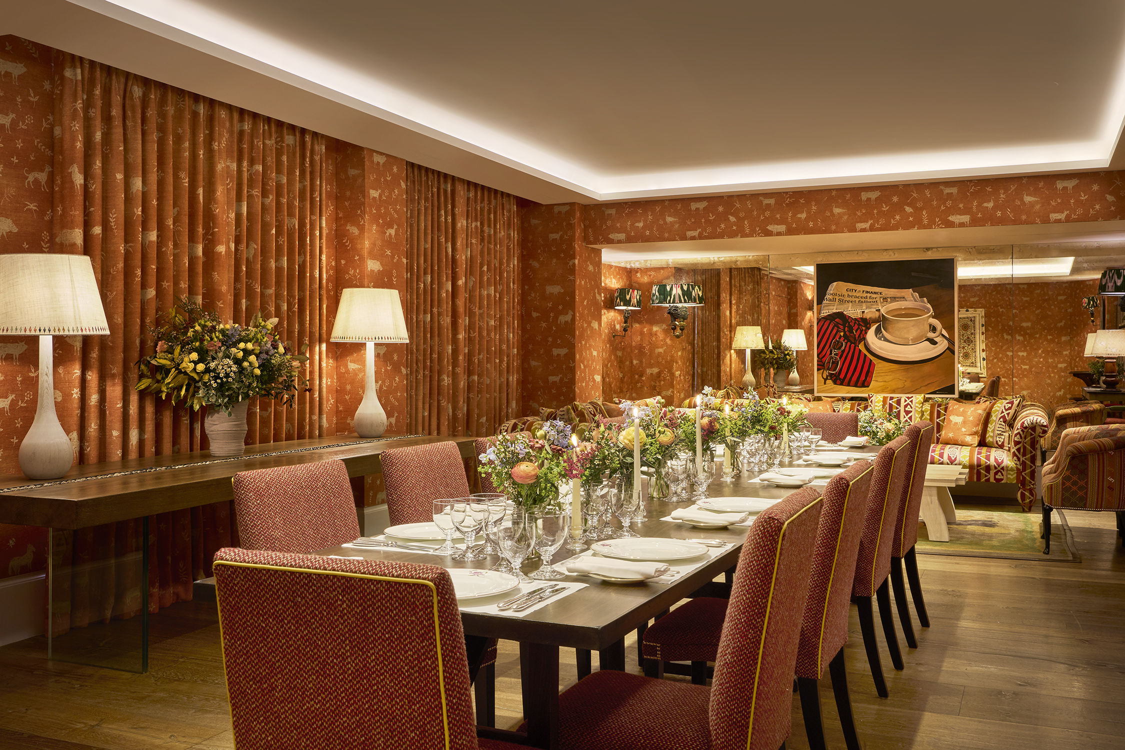 Night shot of a long dining table in the Rocklin private events room at Haymarket Hotel