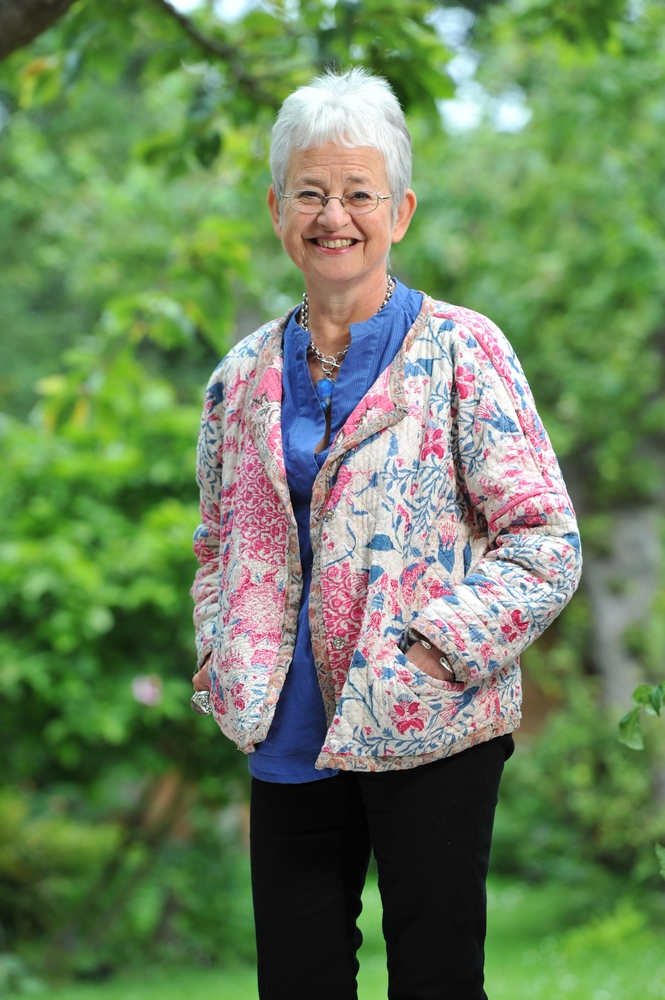 A portrait of author Jacqueline Wilson standing in a garden