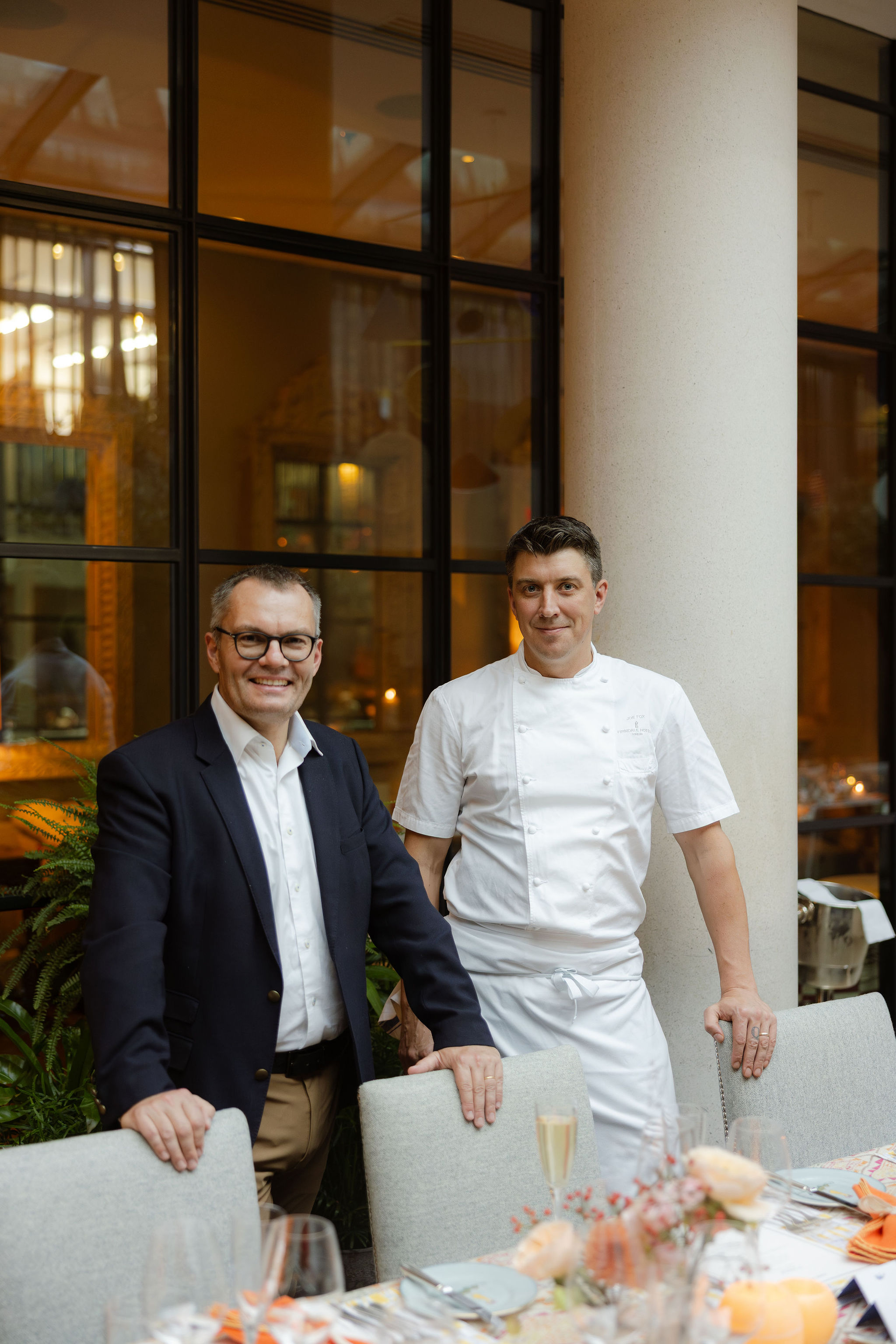 Wine maker Benoit Dehu stands with Firmdale's Group Head Chef, Joe Fox in The Orangery at Ham Yard Hotel