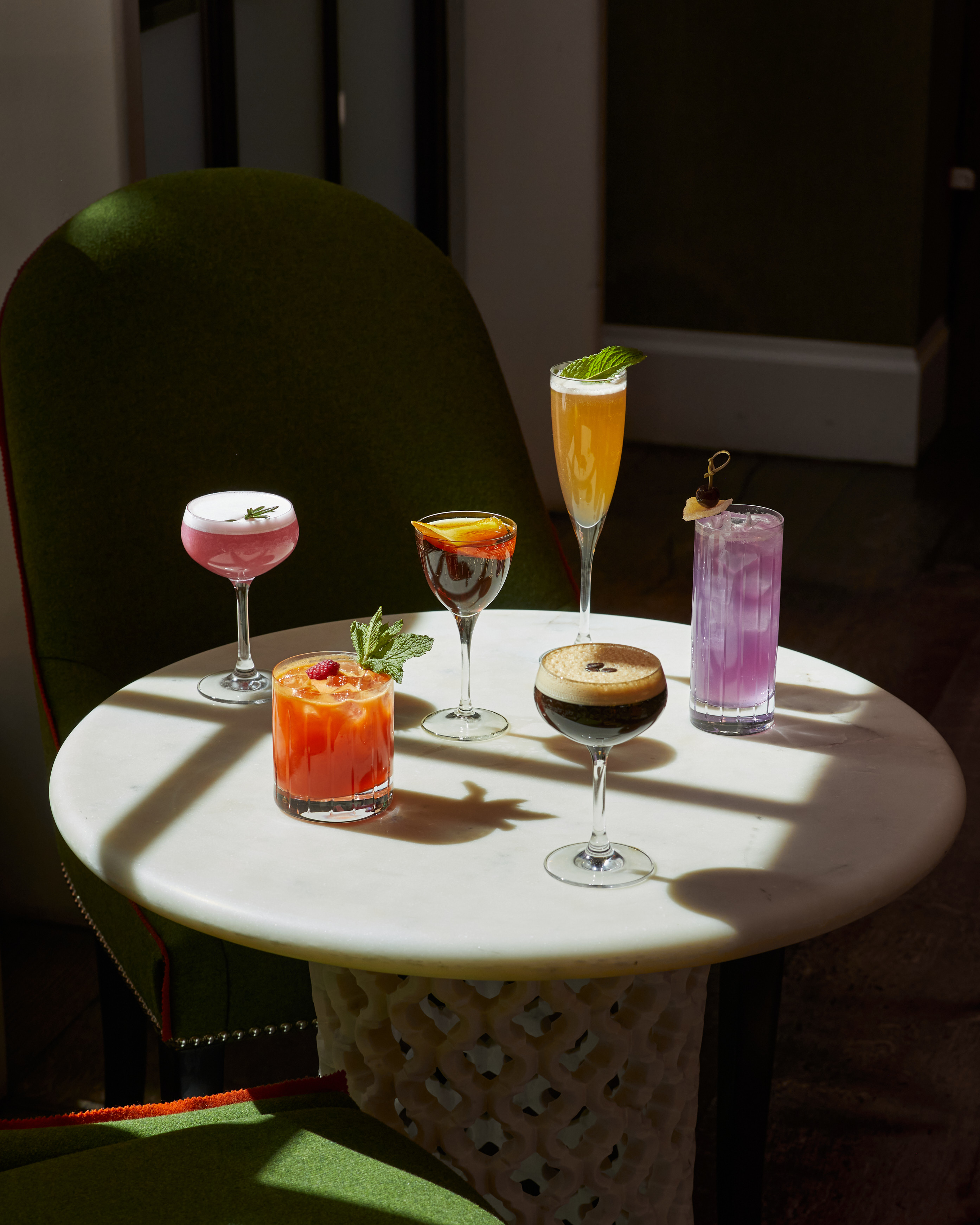 An image of multiple cocktails on a table in The Crosby Bar.