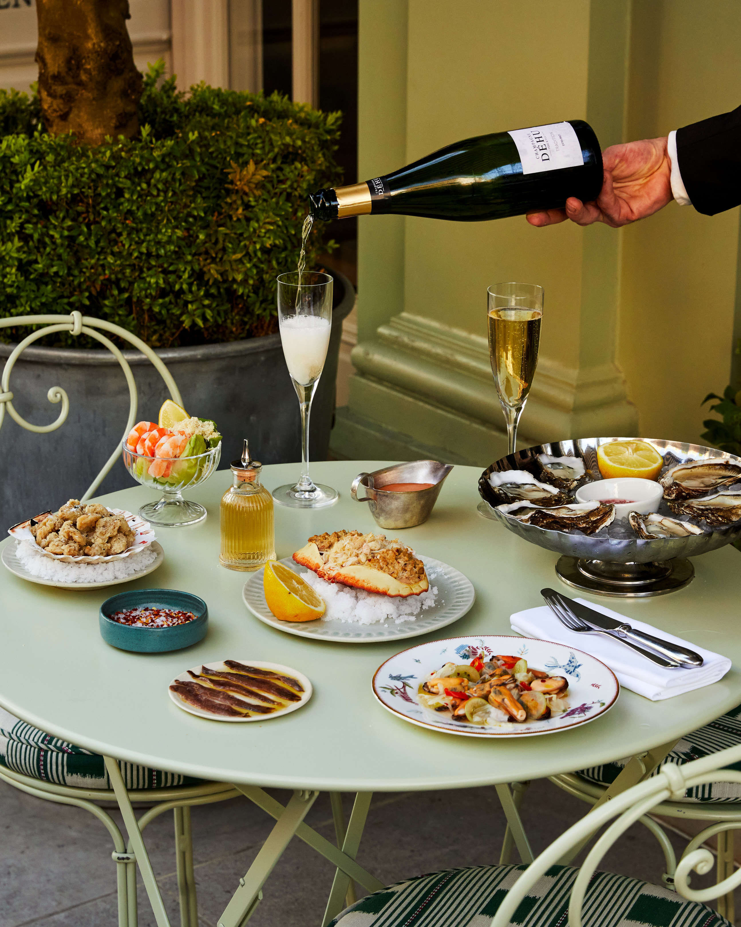 Multiple seafood dishes shot on the patio at Charlotte Street Hotel. Including Oysters, Crab, and other seafood dishes.
