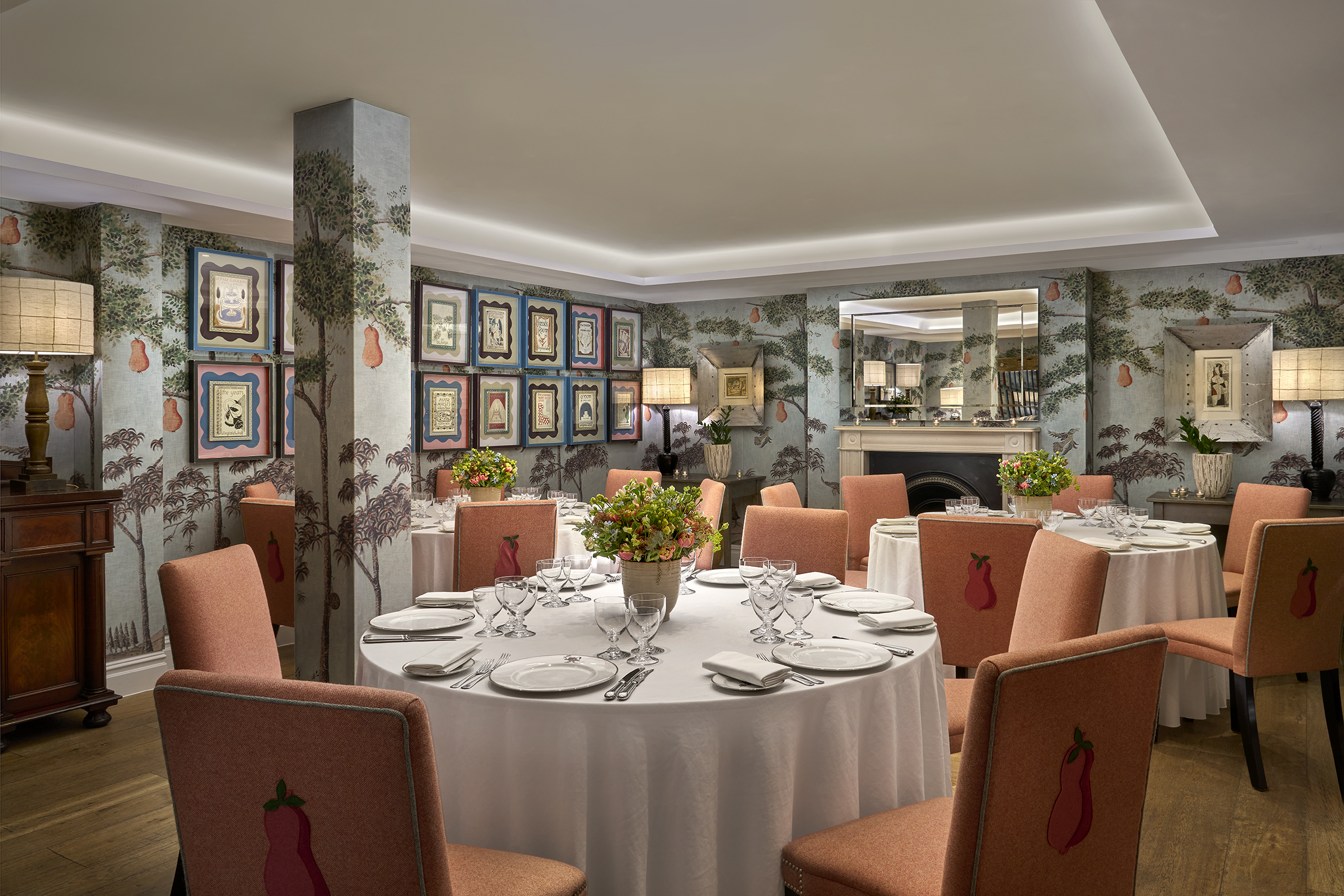 Round dining tables set-up in the Duncan Grant private events room at Charlotte Street Hotel