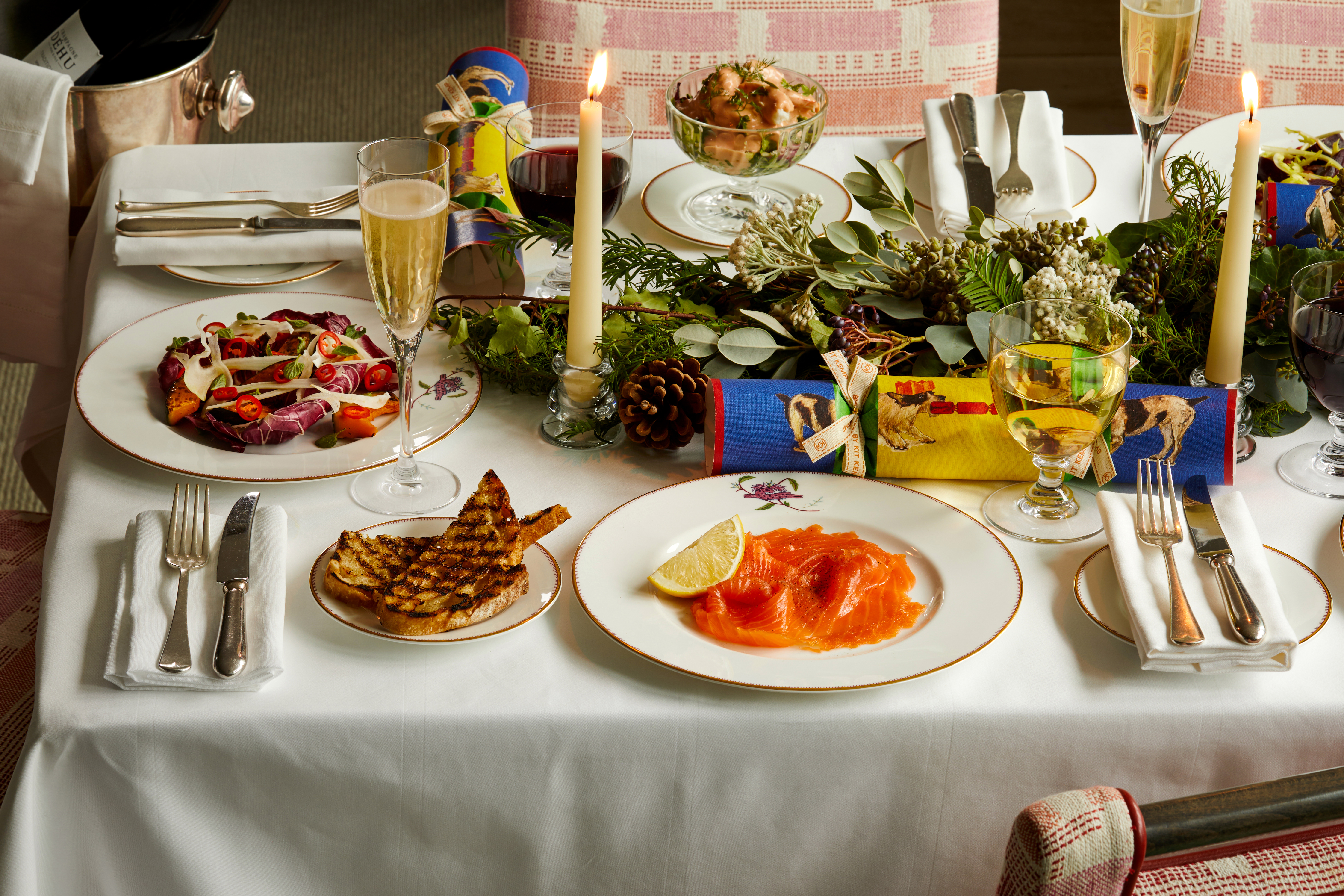 Wide shot of festive dining set-up with Champagne on Mythical Creatures bespoke crockery