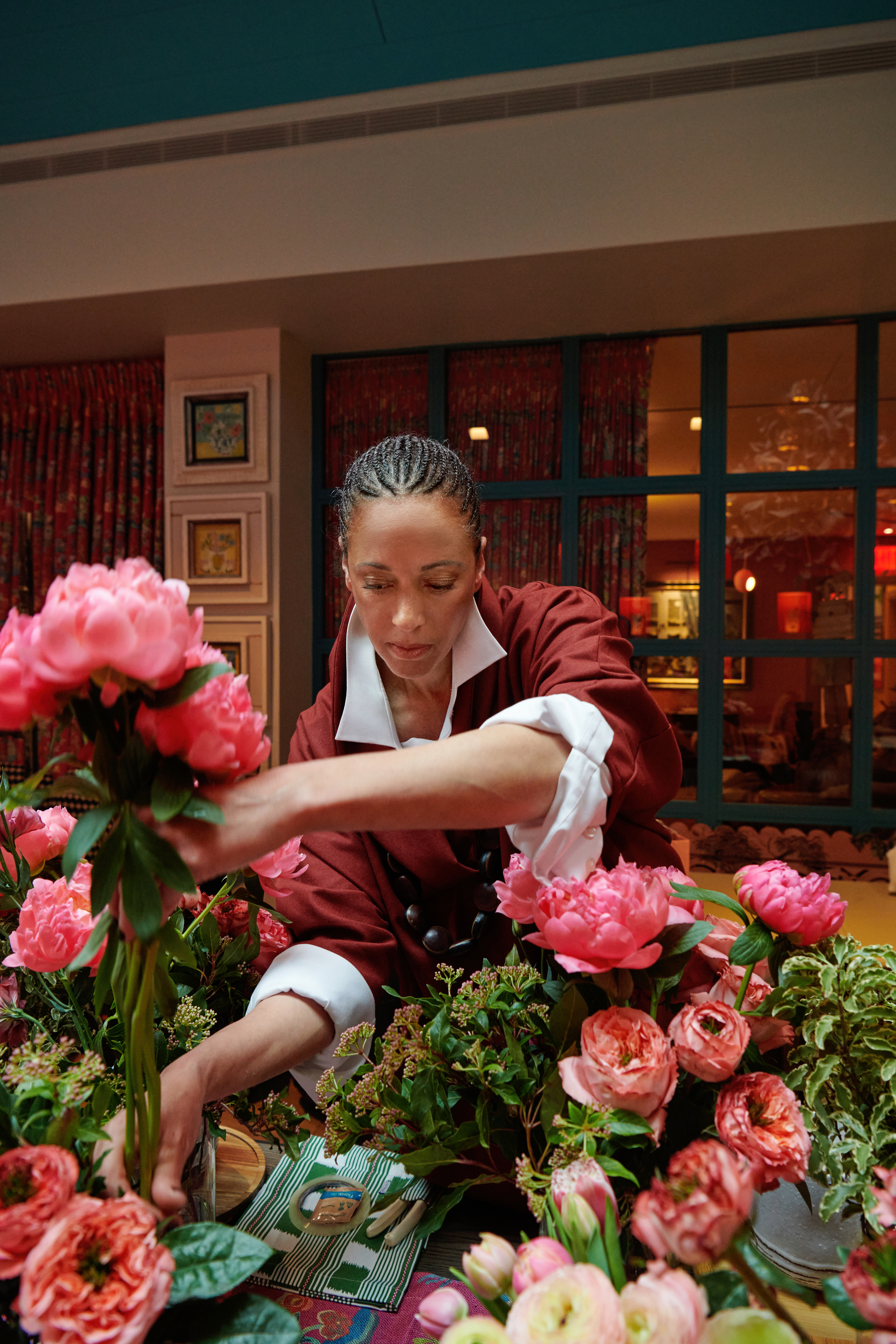 Shot of floral designer Tawana Schlegel arranging some bright pink flowers