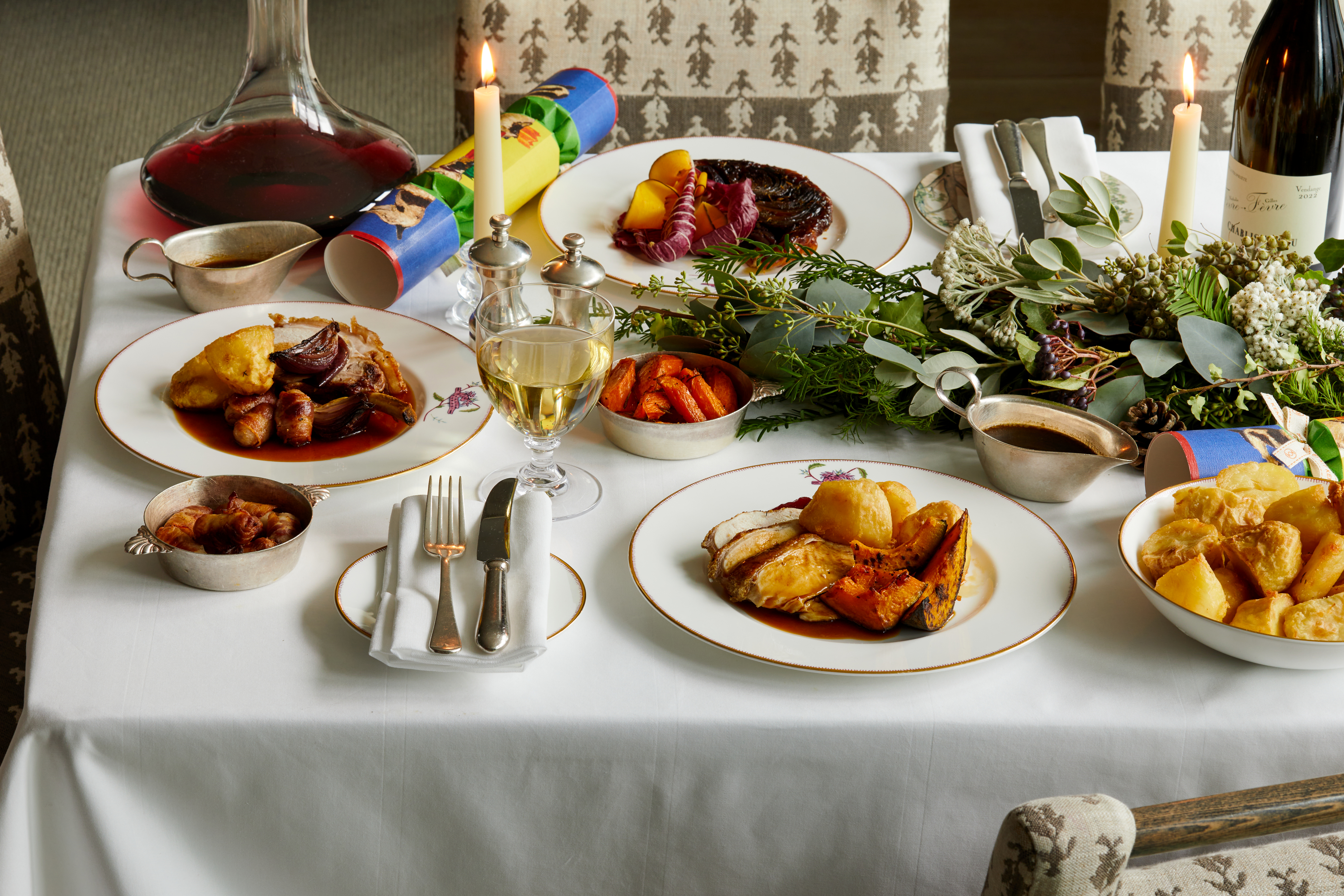 Wide shot of festive dining set-up with wine on Mythical creatures bespoke crockery