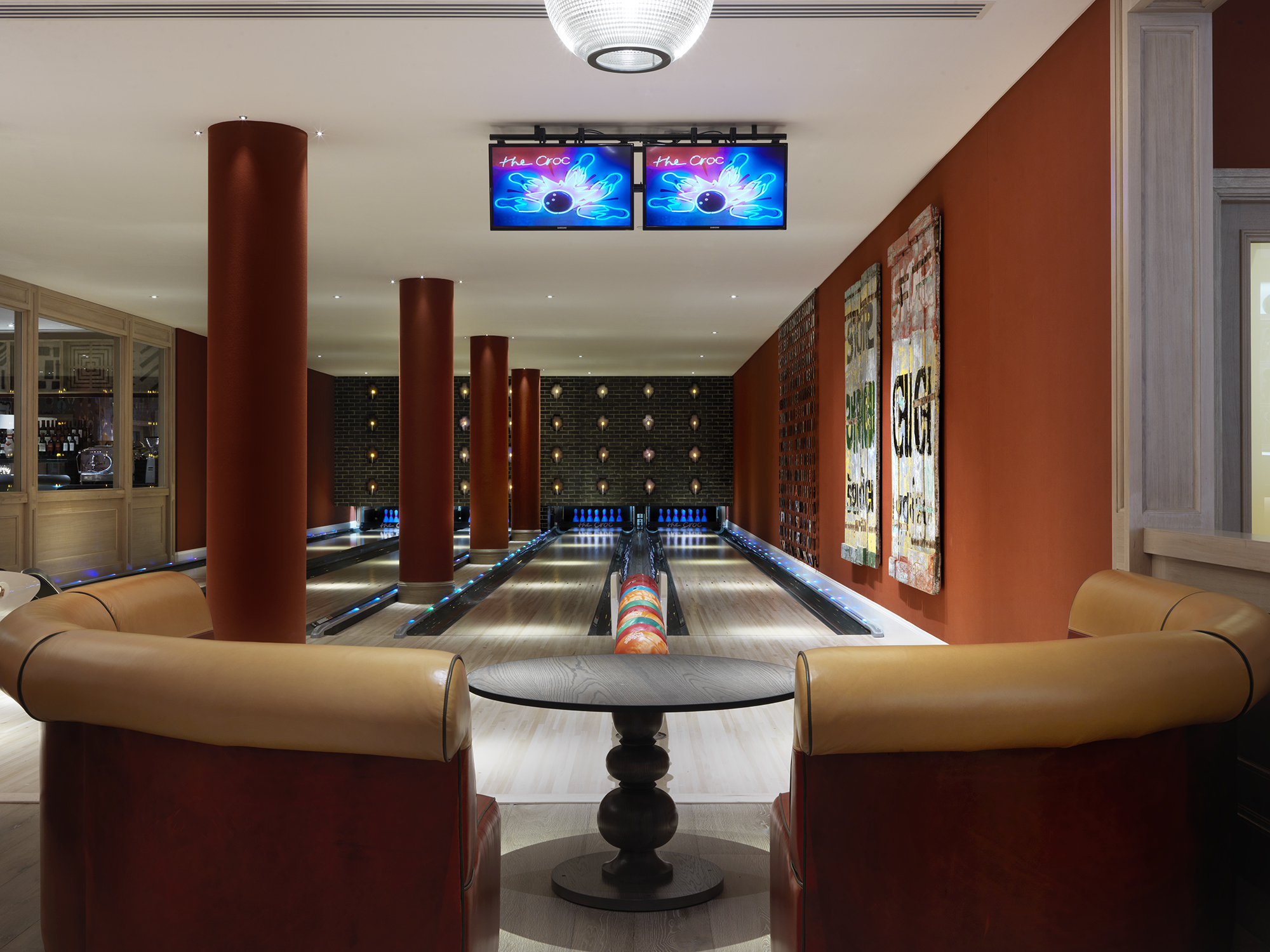 Close shot of a seating area and Croc Bowling Alley at Ham Yard Hotel