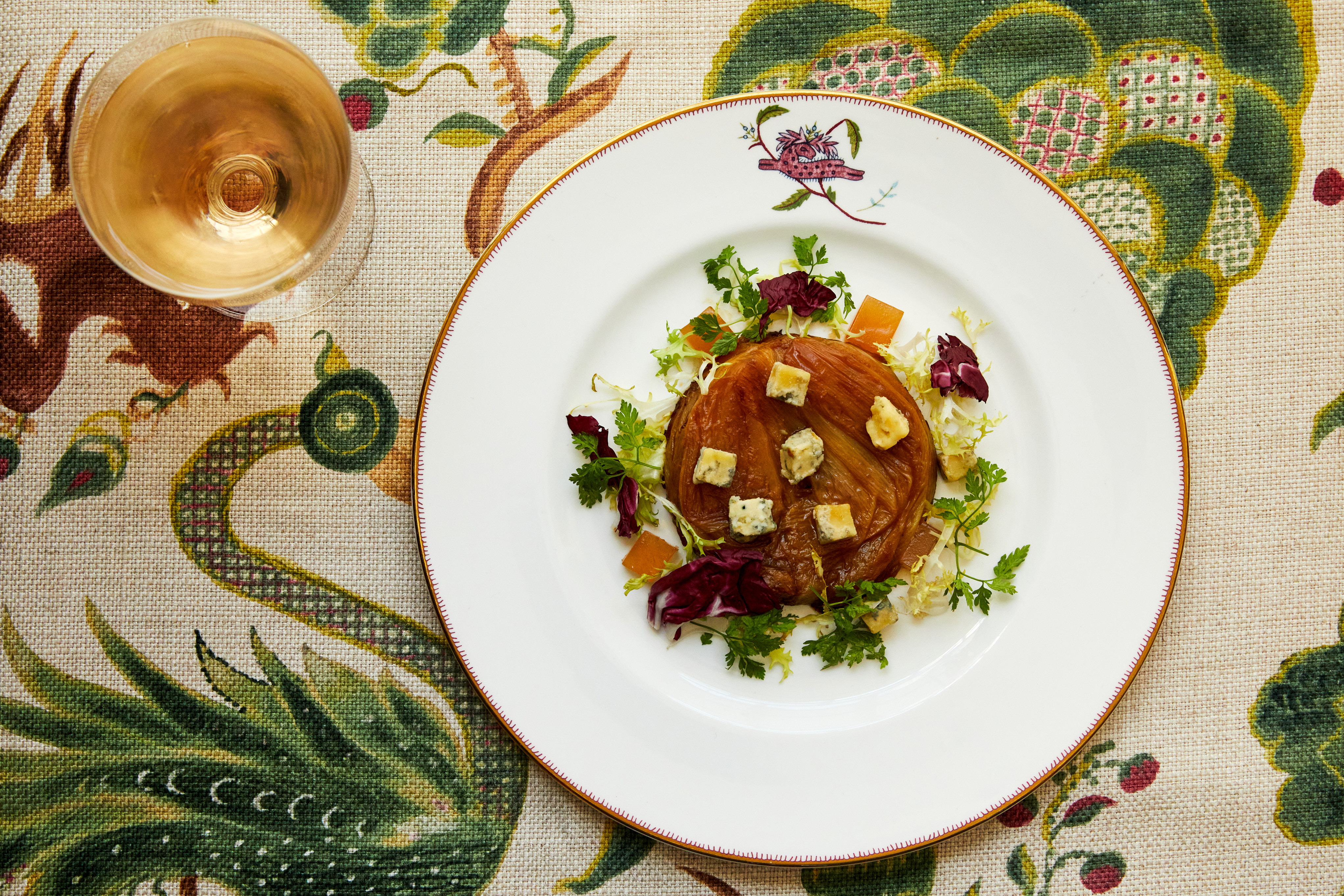 An image of an onion tart on a plate, at Refuel, Soho Hotel.