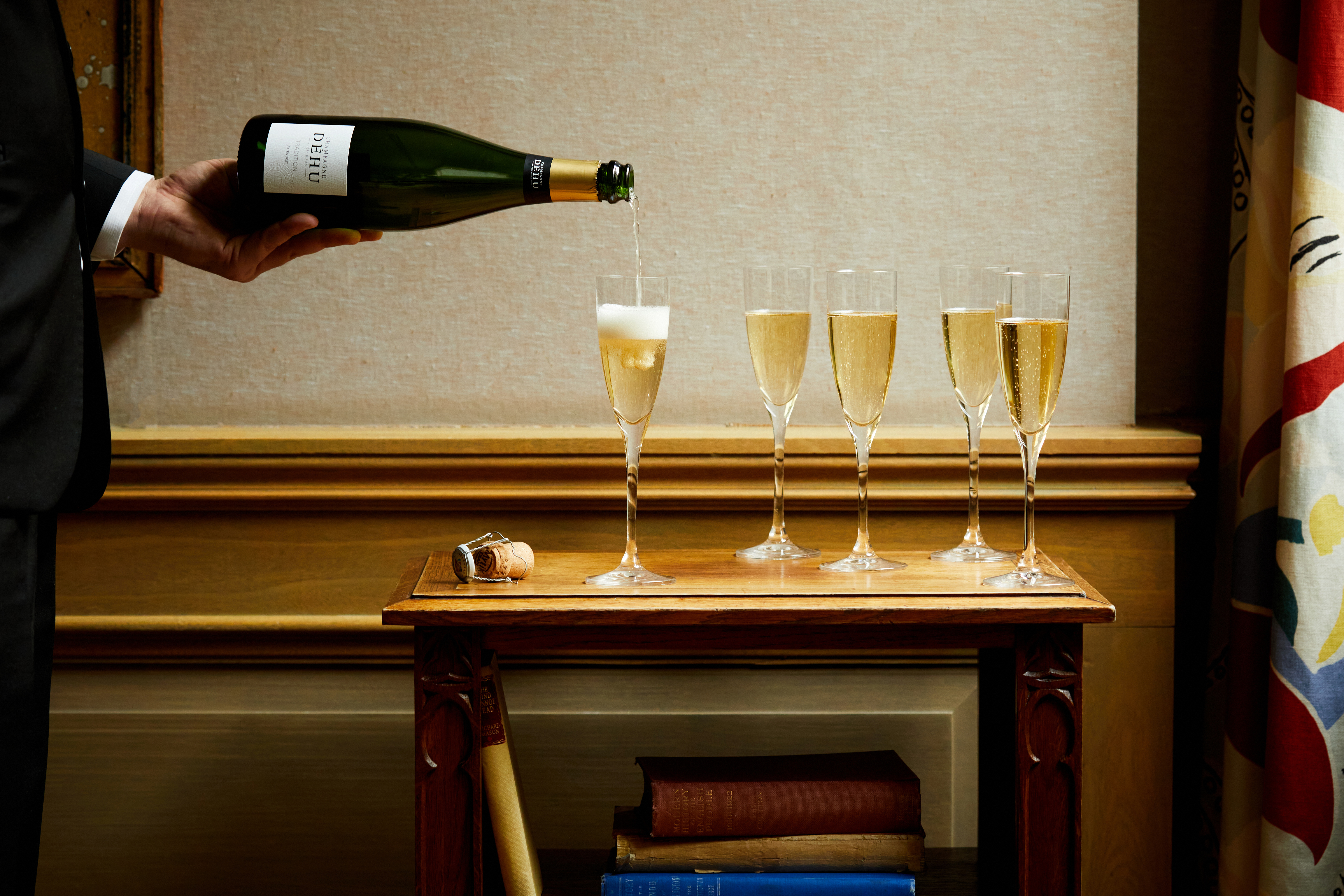 Champagne is poured into flutes by waiter
