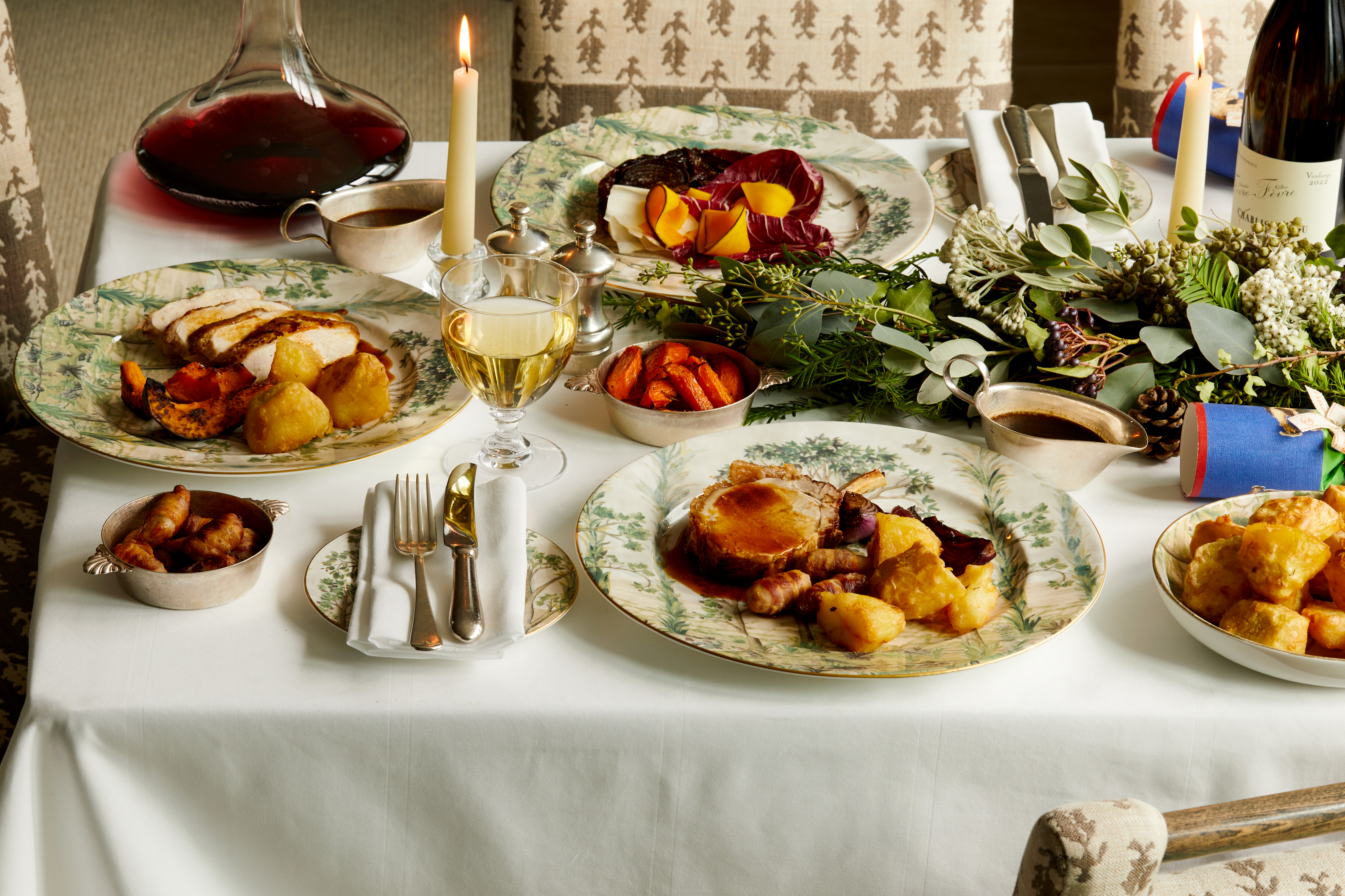 Wide shot of festive dining set-up with wine on Tall Trees bespoke crockery