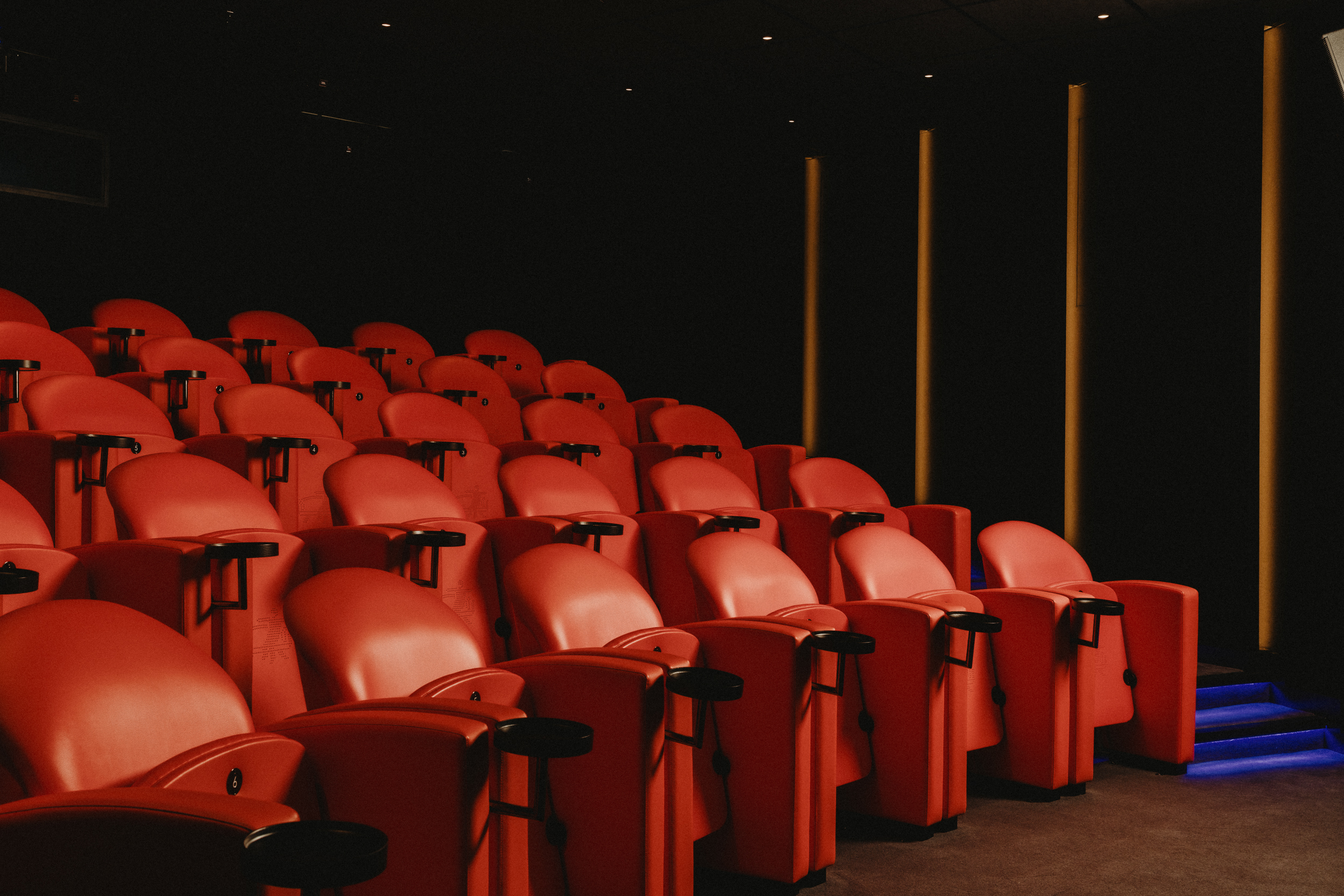 Diagonal shot across the red seating in the screening room at Covent Garden Hotel