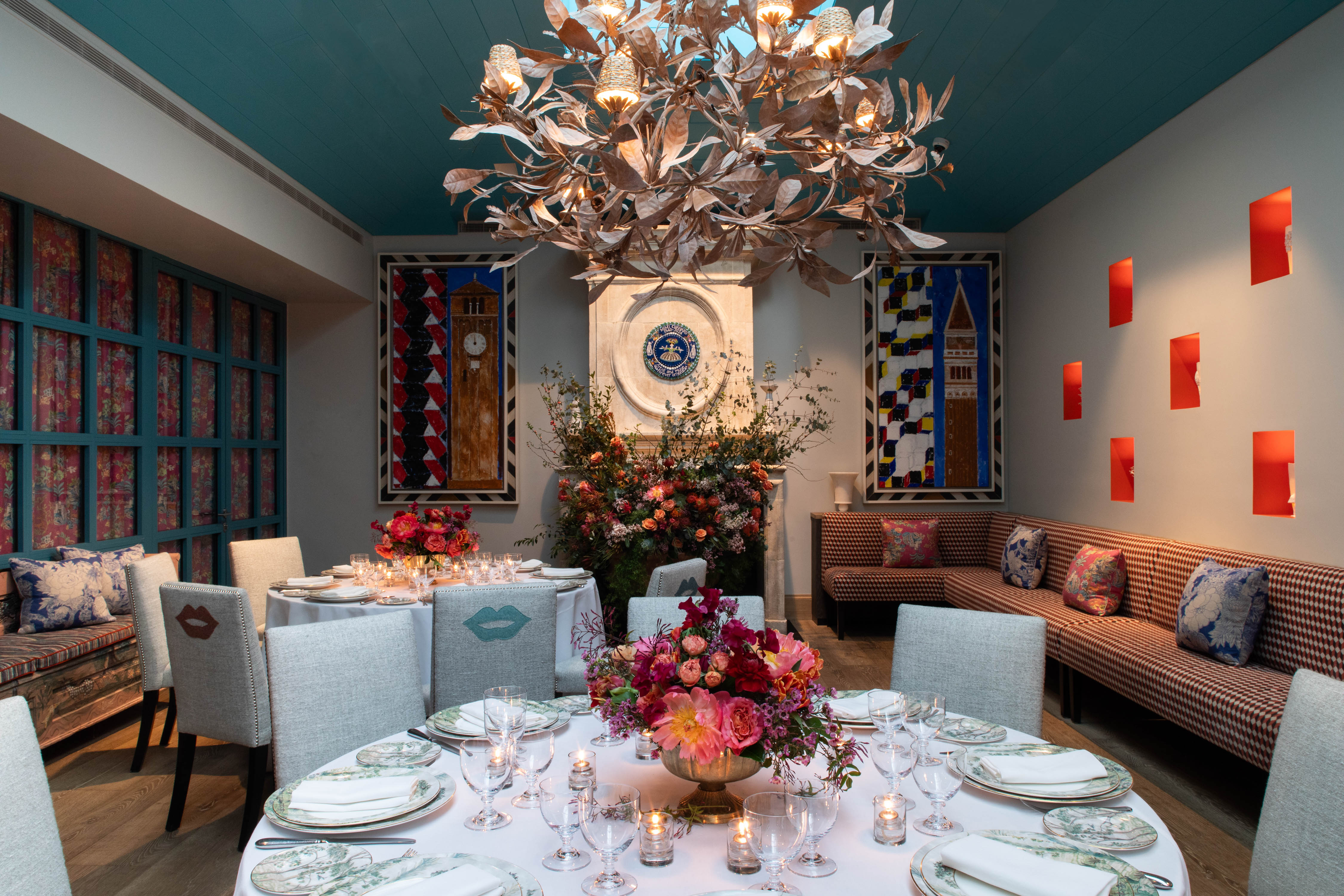A close up shot of round wooden table with four chairs in The Orangery at Warren Street Hotel.