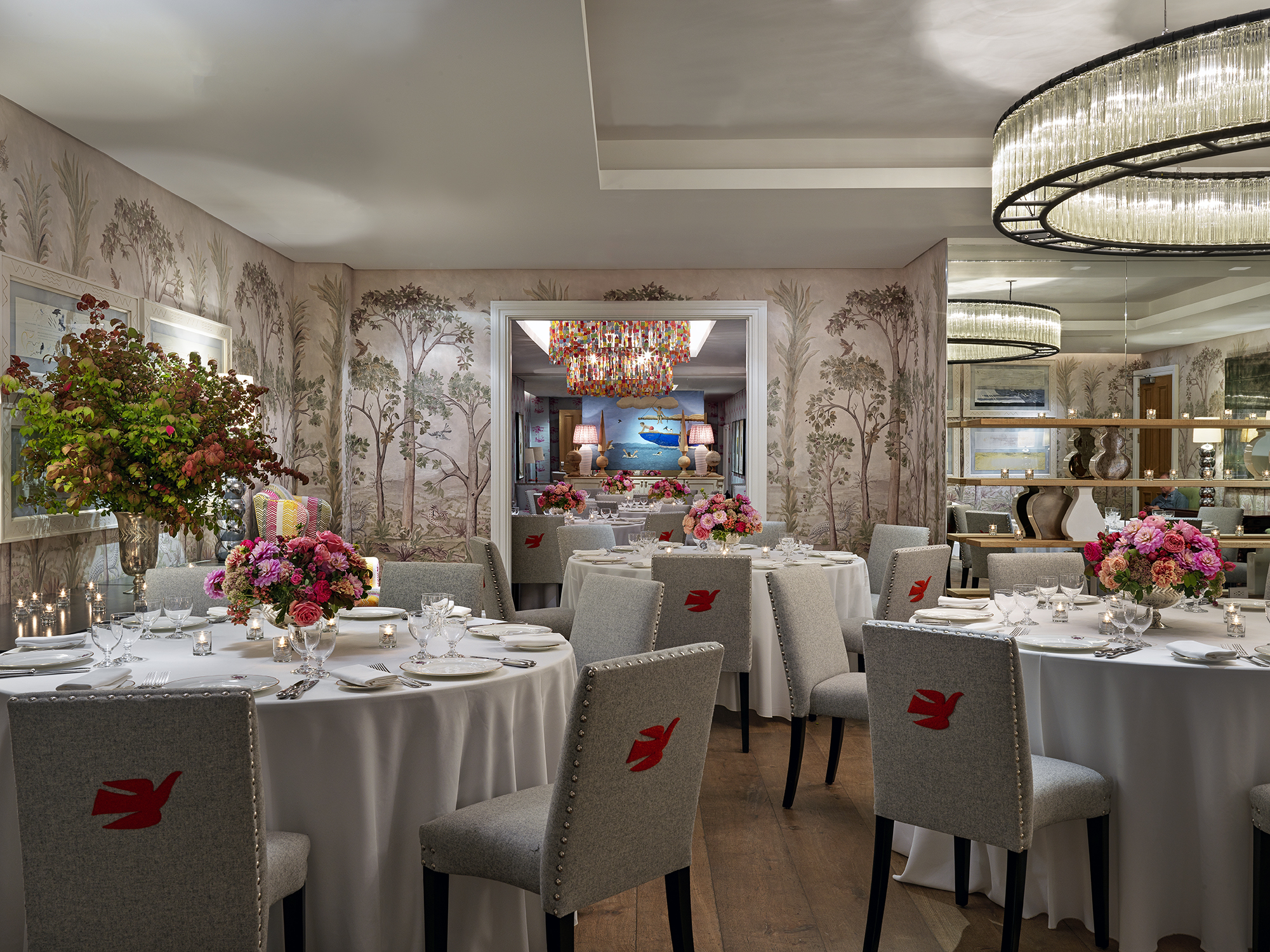 Round dining tables set-up in the Prince private events room looking over the Spring room at Crosby Street Hotel
