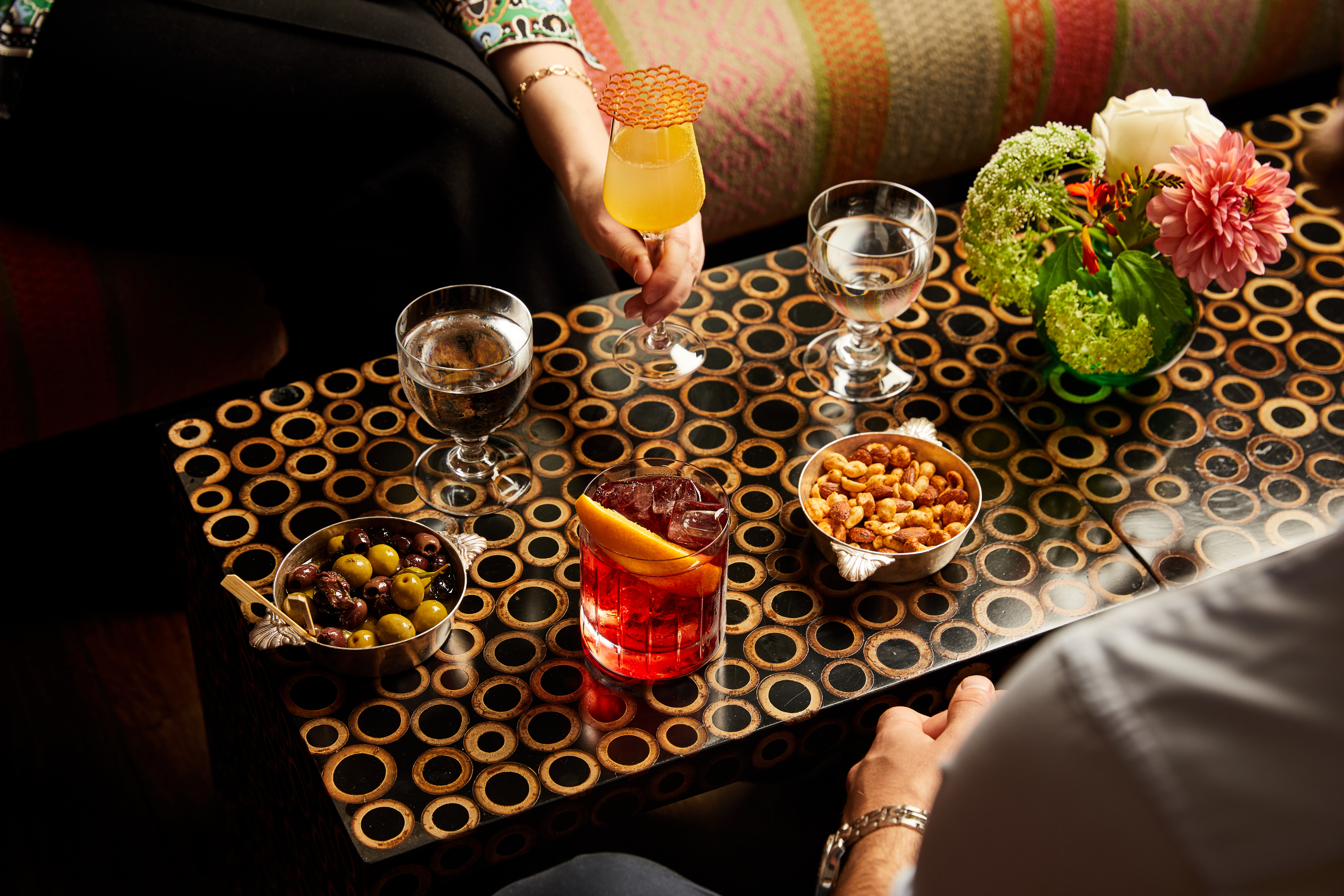 Close shot a bar table with cocktails and bar snacks at Refuel